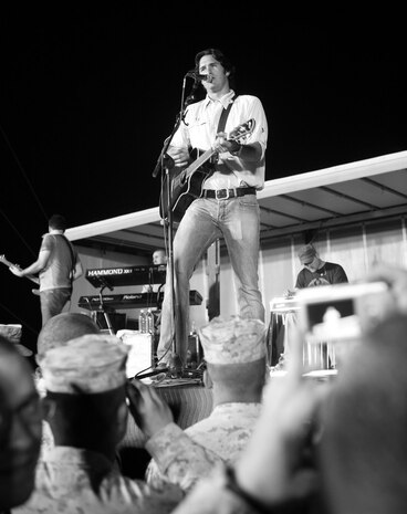 Joe Nichols and his band play to a crowd of U.S. service members and others at a concert aboard Camp Al Taqaddum, Iraq, June 6, 2009. The show was part of the country music star's ten-day tour of the country to honor the men and women who serve in the armed forces. (U.S. Marine Corps photograph by Cpl. Bobbie A. Curtis)