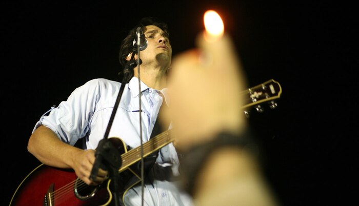 A crowd member holds up a lighter to one of Joe Nichols slower songs at a concert aboard Camp Al Taqaddum, Iraq, June 6, 2009. The show was part of the country music star's ten-day tour of the country to honor the men and women who serve in the armed forces. (U.S. Marine Corps photograph by Cpl. Bobbie A. Curtis)