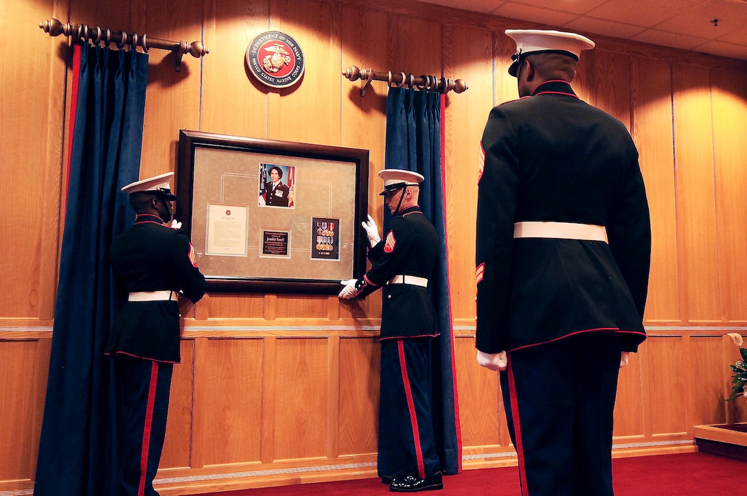 Marine noncommissioned officers from the 4th Marine Corps District mount a memorial plaque dedicated to Cpl. Jennifer M. Parcell on the wall of the Baltimore Military Entrance Processing Station ceremony room Saturday. Parcell was killed in February 2007 in Barwanah, Iraq, by a female suicide bomber while assigned to 3rd Marine Logistics Group, 3rd Marine Expeditionary Force.