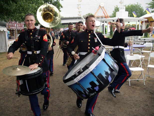 Sgt. Cameron Rodgers, 21, and Cpl. Jonathan Pratt, 24, ignite the crowd with a party band performance at the Waterfront Village June 5, during the Portland Rose Festival. The party band roams around having fun and firing-up the crowd for the big band show that followed.