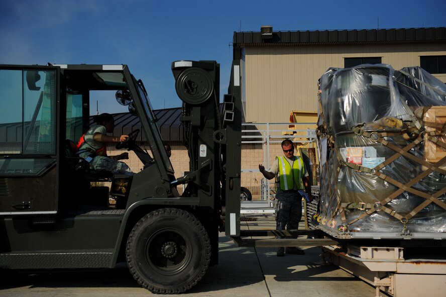 MOODY AIR FORCE BASE, Ga. -- Staff Sgt. Dane Crane, 23rd Logistic Readiness Squadron petroleum, oils and lubricants supervisor, signals the driver of a fork lift while ensuring the forks are properly placed in a pallet during an operational readiness exercise here June 3. (U.S. Air Force photo by Senior Airman Gina Chiaverotti)