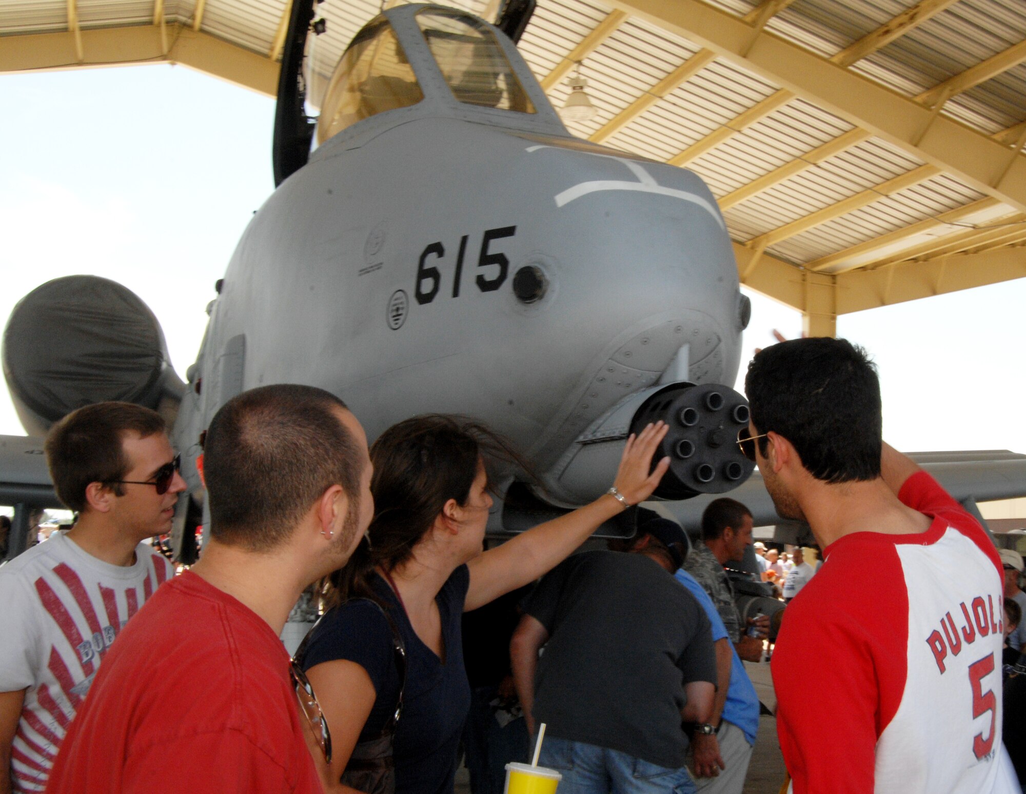 WHITEMAN AIR FORCE BASE, Mo. - Spectators admire the gatling gun of an A-10 Thunderbolt II static display June 6 during the Wings Over Whiteman Airshow.  (U.S. Air Force photo/Master Sgt. Stan Coleman)