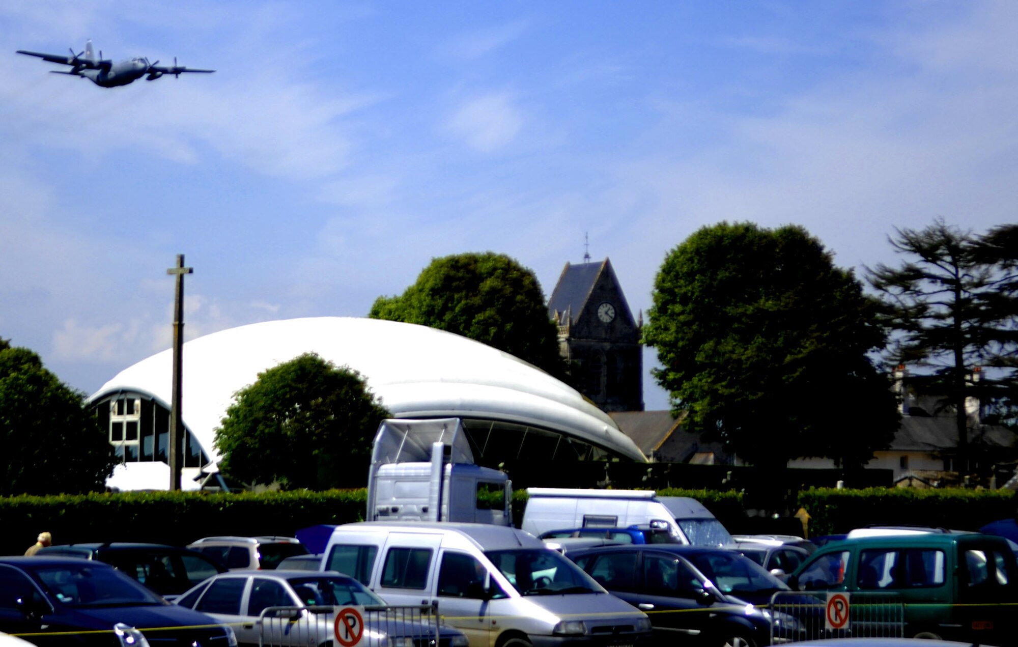 An Air Force C-130 from the 86th Airlift Wing, Ramstein Air Base, Germany flies above the skies of Sainte-Mère-Église, France, 5 June 2009 in preparation for the 65th Anniversary of D-Day remembrance ceremony held each year in Normandy, France. More than 300 Army paratroopers will be jumping out of the Hercules over the beaches of Normandy. Each year since the liberation of Normandy, U.S. forces along with other nations come together to honor those who gave the ultimate sacrifice on that day. This year's ceremony is scheduled to be attended by U.S. President Barrack Obama and dozens of American World War II veterans.(U.S. Air Force photo by Tech. Sgt. Michael Voss)