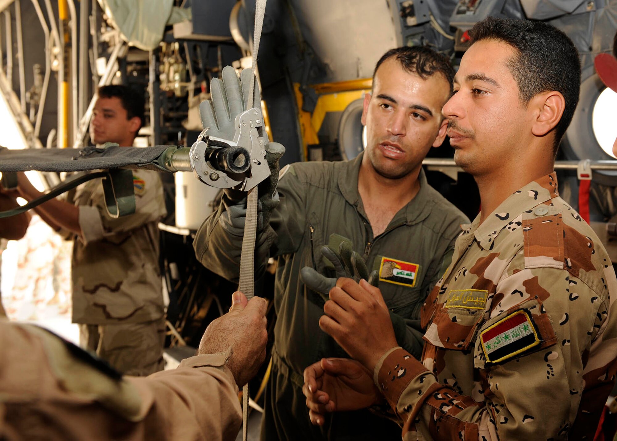 Iraqi air force Lieutenant Tahssen, nurse and flight medic instructor, explains the steps for securing a litter on the C-130 Hercules aircraft to Iraqi flight medic students at New Al-Muthana Air Base, Iraq June 2, 2009.  The four week course, once taught by U.S. instructors, is now instructed by Iraqis. After the training the flight medics will be able to convert C-130 Hercules aircraft into aero-medical evacuation transports.   (U.S. Air Force photo by Senior Airman Jacqueline Romero)