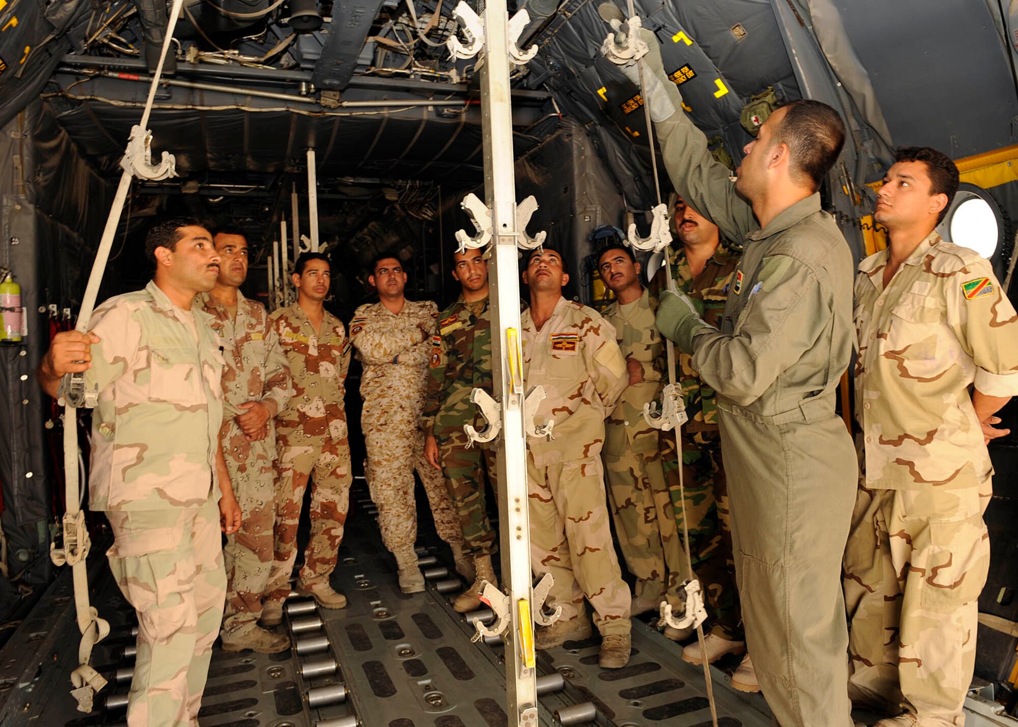Iraqi air force Lieutenant Tahssen , nurse and flight medic instructor, explains the procedures to reconfigure a C-130 Hercules aircraft for aero-medical evacuation transport to Iraqi flight medic students at New Al-Muthana Air Base, Iraq June 2, 2009.  The four week course, once taught by U.S. instructors, is now instructed by Iraqis.  (U.S. Air Force photo by Senior Airman Jacqueline Romero)