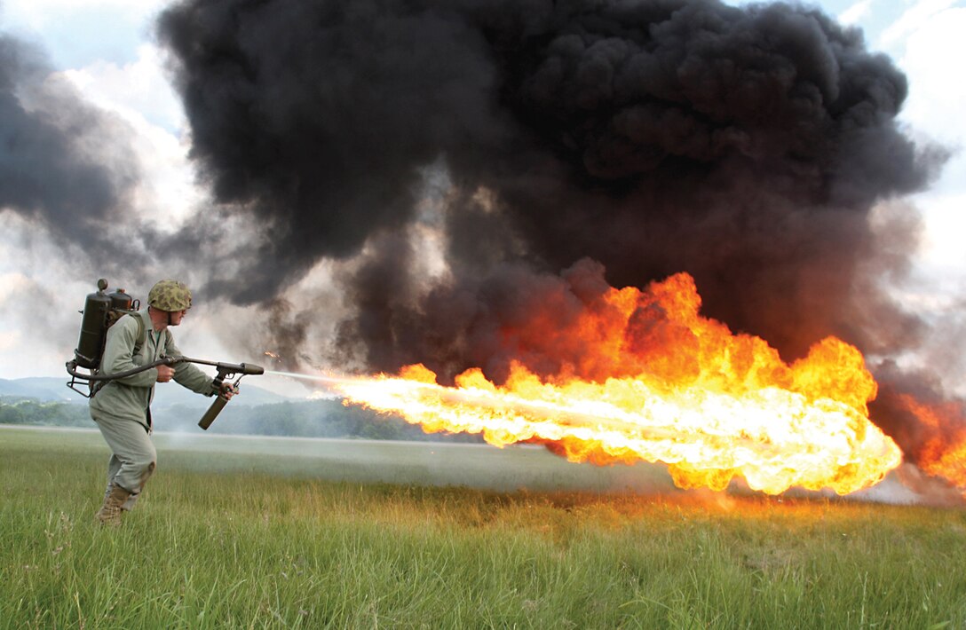 Ray Cording operates a WWII-era M2 Flame Thrower to devastate a Japanese bunker June 6 during a presentation of a tactical assault at the World War II Weekend in Reading, Pa. The flame throwers add a visually engaging aspect to the Living History Detachment's demonstration and are an annual fan favorite.