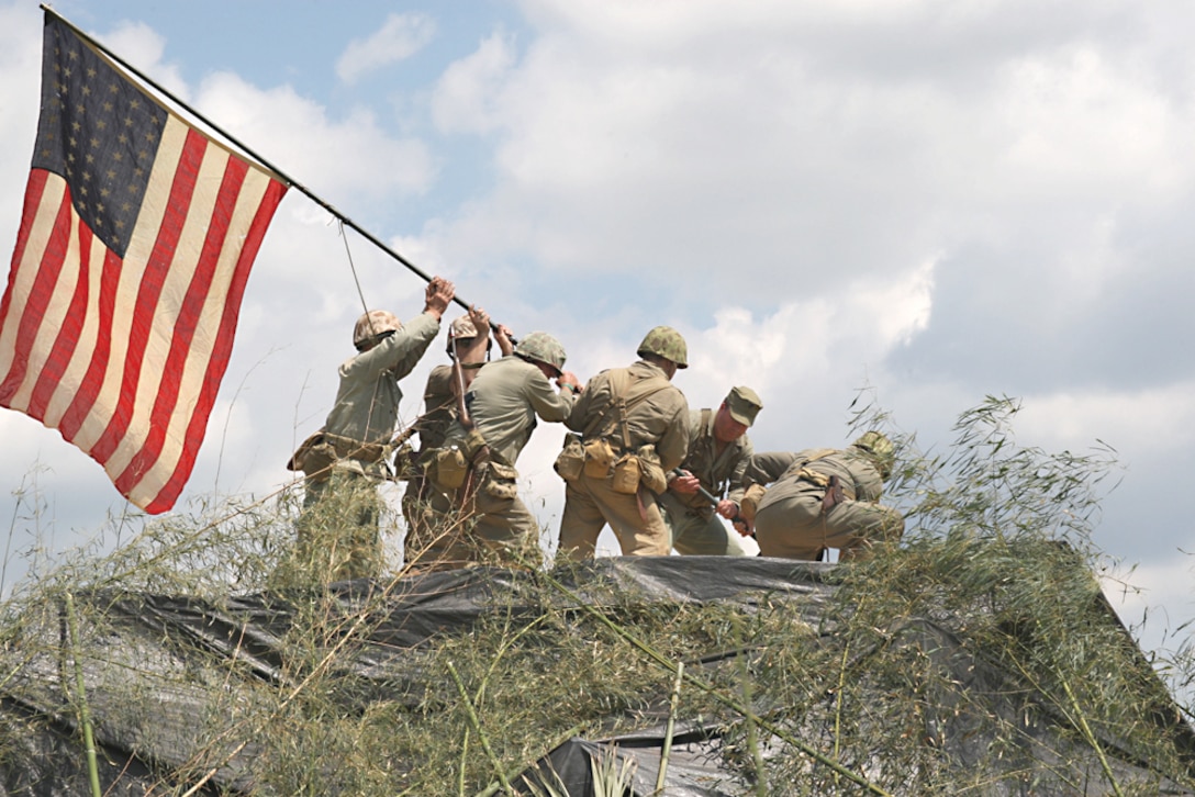 The Marines of the LHD raise the flag on “Mount Suribachi” in honor of the fighting men of World War II during the WWII Weekend in Reading, Pa. The flag raising was accompanied by a stirring narration and followed by the Marine Corps Hymn, and an audience member said the presentation sent chills down his spine.