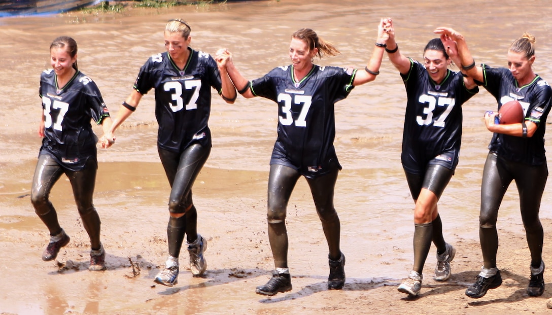 Team members race to the finish line of Marine Corps Community Services-Camp Pendleton annual 10k Mud Run at Lake O'Neil, June 7. The team was one of sixty teams who participated in the race this year.
