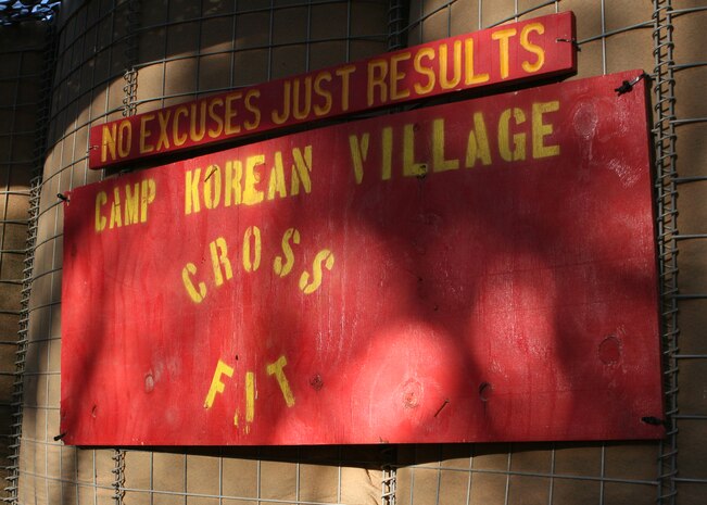 The improvised gym aboard Camp Korean Village, Iraq, is made up of bits and pieces of extra weight and exercise equipment as well as objects you can find aboard any Marine Corps base such as ammunition cans filled with dirt. Camp Korean Village has been without an actual gym facility since early March.  (U.S. Marine Corps photo by Lance Cpl. Melissa A. Latty)