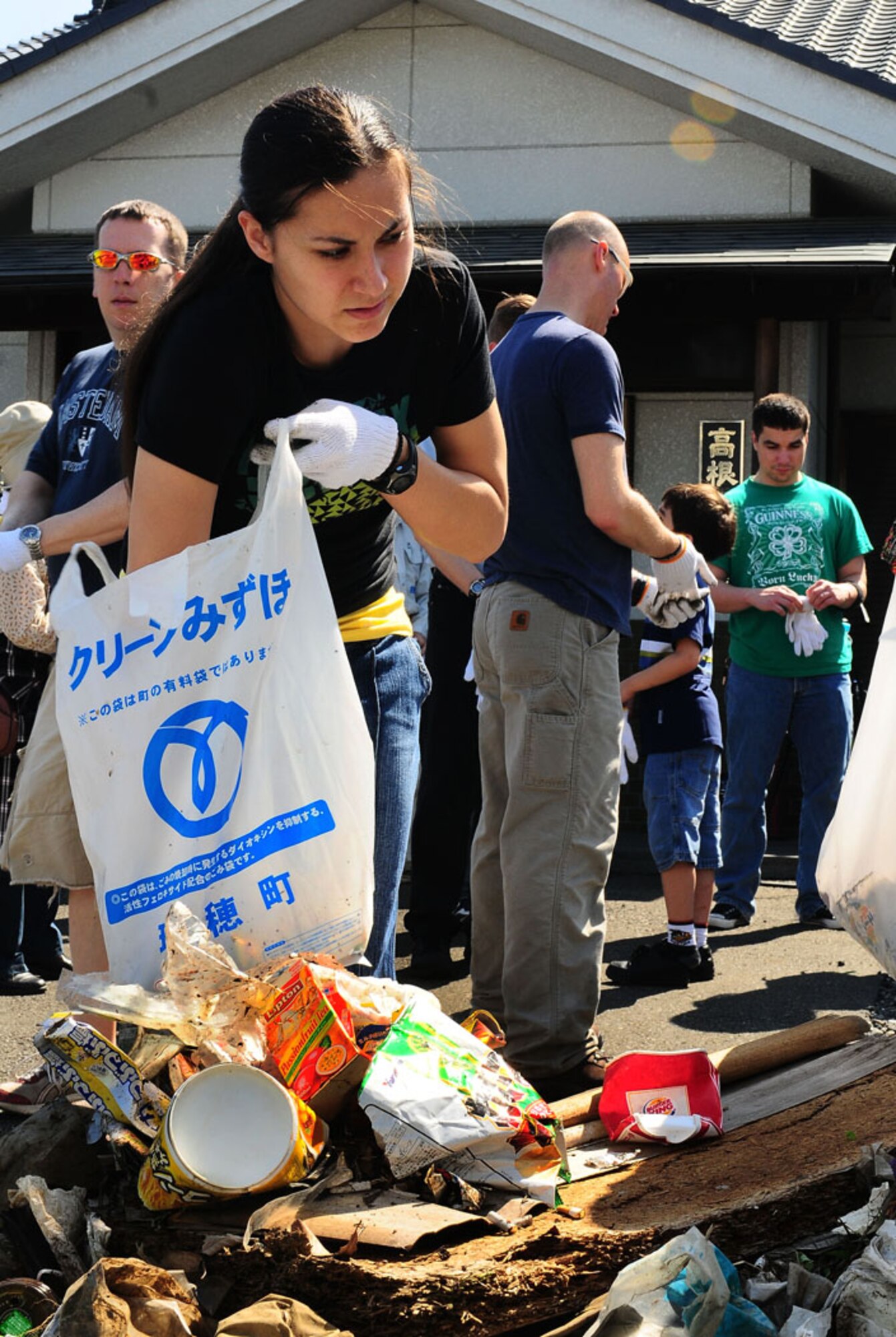 MIZUHO, Japan -- Senior Airman Mercedes Swenson, 374th Maintenace Group, sorts trash collected during the 27th Annual Mizuho Town Cleanup June 7, as part of Japan's environmental month. Airman Swenson was one of 30 Team Yokota members that participated in the event. The purpose of this event was to make Mizuho a better place to live by working together to promote environment awareness. (U.S. Air Force photo/Airman First Class Devin Doskey)