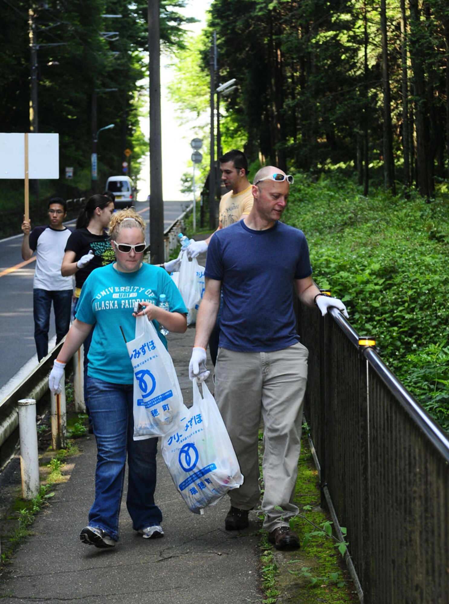 MIZUHO, Japan -- Chief Master Sgt. Allen Mullinex, 374th Maintenance Group, and daughter Alicia look for trash to pick-up during the 27th Annual Mizuho Town Cleanup June 7, as part of Japan's environmental month. Chief Mullinex was one of 30 Team Yokota members that participated in the event. The purpose of this event was to make Mizuho a better place to live by working together to promote environment awareness. (U.S. Air Force photo/Airman First Class Devin Doskey)
   
