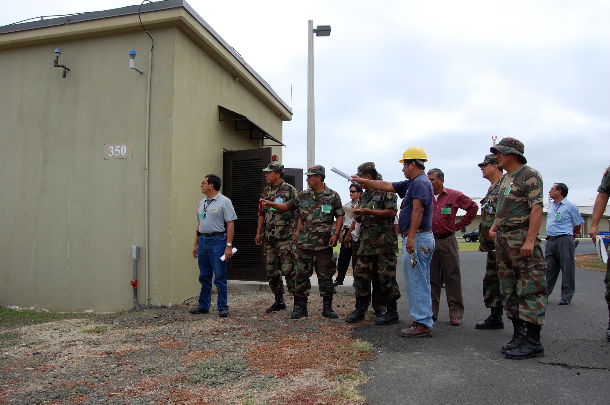 Mr. Pedro Plua (yellow hat), contract employee with ITT, walks government of Ecuador personnel through generator equipment during a FOL Manta orientation June 3. (U.S. Air Force photo by 1st Lt. Beth Woodward)