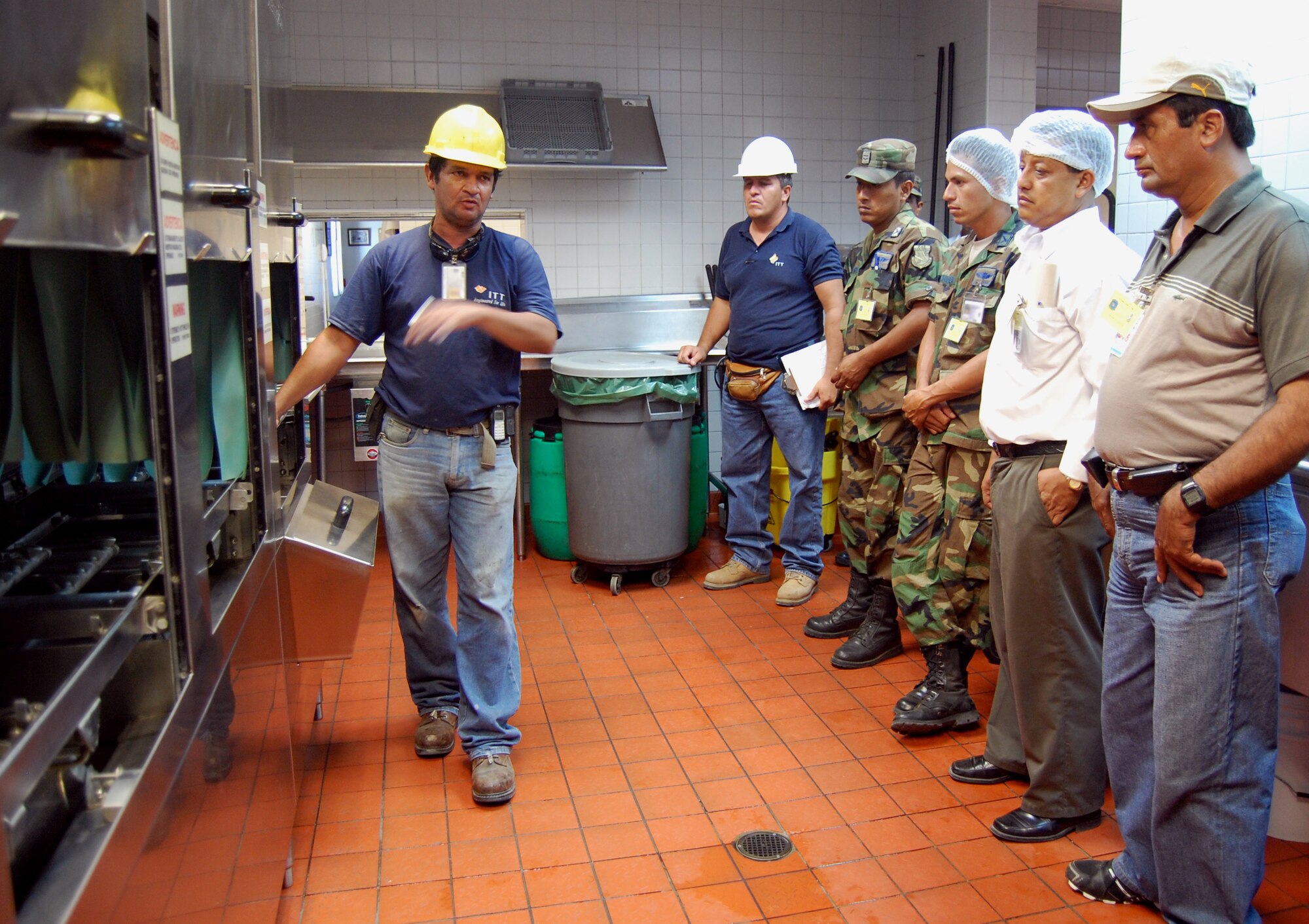 Mr. Pedro Loor (far left), contract employee with ITT civil engineering, explains safety issues in the FOL Manta dining facility to government of Ecuador personnel June 3 during an orientation. (U.S. Air Force photo by 1st Lt. Beth Woodward)