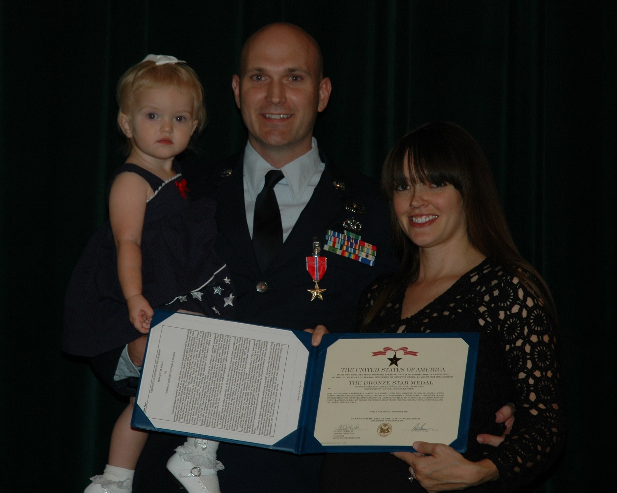 Tech. Sgt. Stephen Hunter, 944th Civil Engineer Squadron Explosive Ordnance Disposal technician, poses with his family after recieving the Bronze Star during commander's call June 6. (U.S. Air Force photo/Tech. Sgt. Susan Stout)