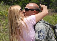 Chief Master Sgt. Paul Albini, 919th Maintenance Squadron, kisses his wife for the first time June 4 at Duke Field, after returning from a deployment to Bagram Air Base, Afghanistan.  Friends and family members came out to welcome back the approximately 30 people who returned June 4.  (U.S. Air Force photo/Staff Sgt. Samuel King Jr.)