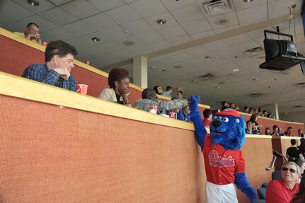 Major General Abraham J. Turner, Chief of Staff, U.S. Strategic Command, high fives Casey the Lion, mascot for the Omaha Royals at Rosenblatt Stadium, Omaha Nebraska on June 7th, 2009. General Turner threw out a ceremonial first pitch and meet with members of the Omaha Royals baseball organization.