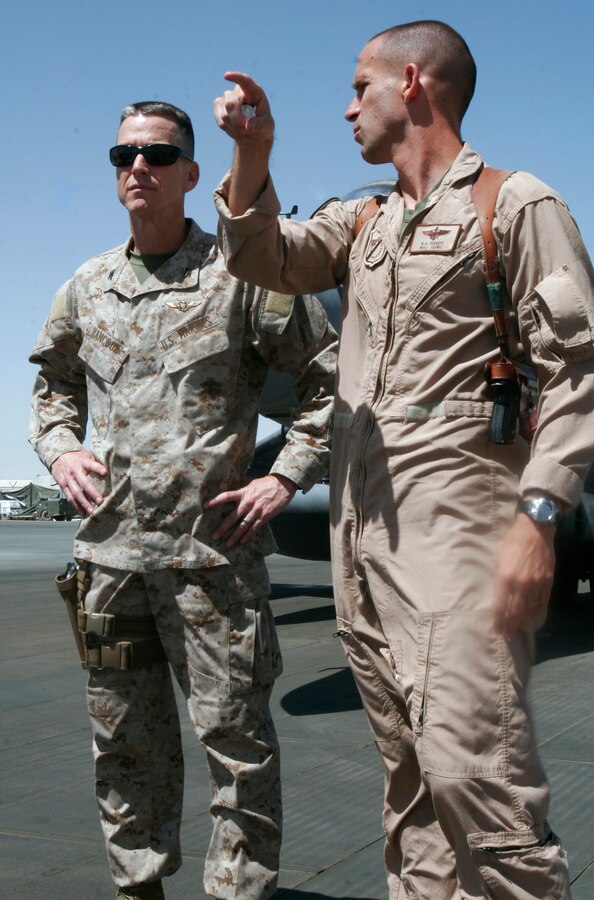 Col. Ben Hancock, senior Marine liaison with Marine Forces Central Command, speaks with Maj. Roger Hardy, Marine Attack Squadron 214 executive officer, on the squadron’s parking ramp at Kandahar Airfield, Afghanistan, June 6, 2009. Hancock, Marine Corps Air Station Yuma’s former commanding officer, is serving a six-month billet with MarForCent as the Marine liaison with the U.S. Air Force and British Royal Air Force for aviation operations in Afghanistan and Iraq.