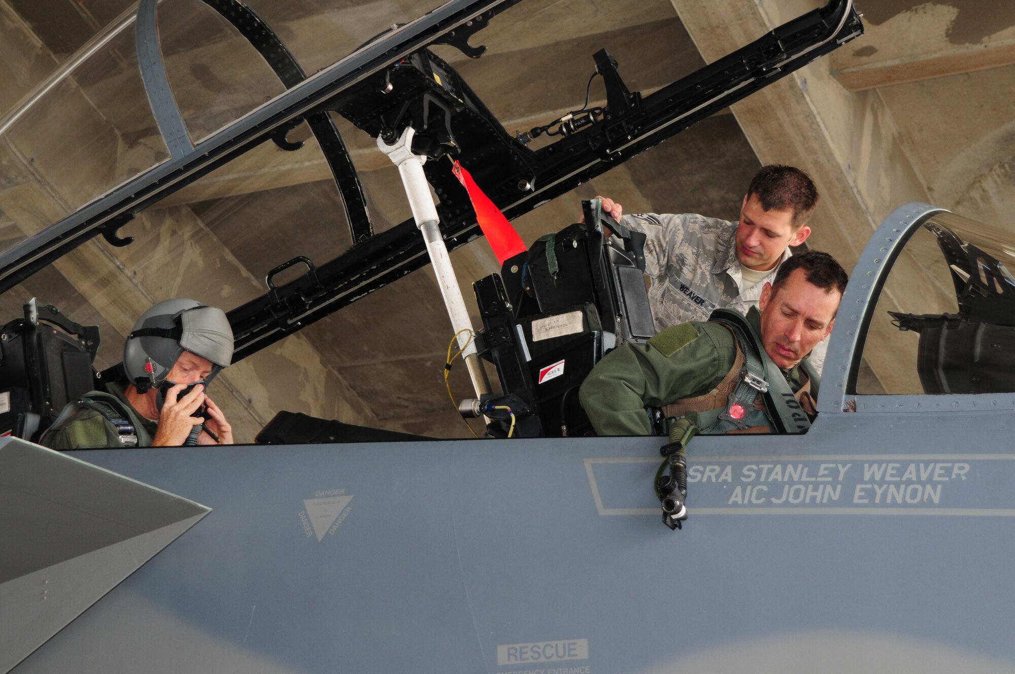 18th Wing Commander Brig. Gen. Brett Williams and Command Chief Master Sgt. Michael Warner get ready to fly during an F-15 familiarization flight as Senior Airman Stanley Weaver, a Crew Chief from the 18th Aircraft Maintenance Squadron, ensures everything is properly secured, May 27. (U.S. Air Force photo/Staff Sgt. Lakisha Croley)