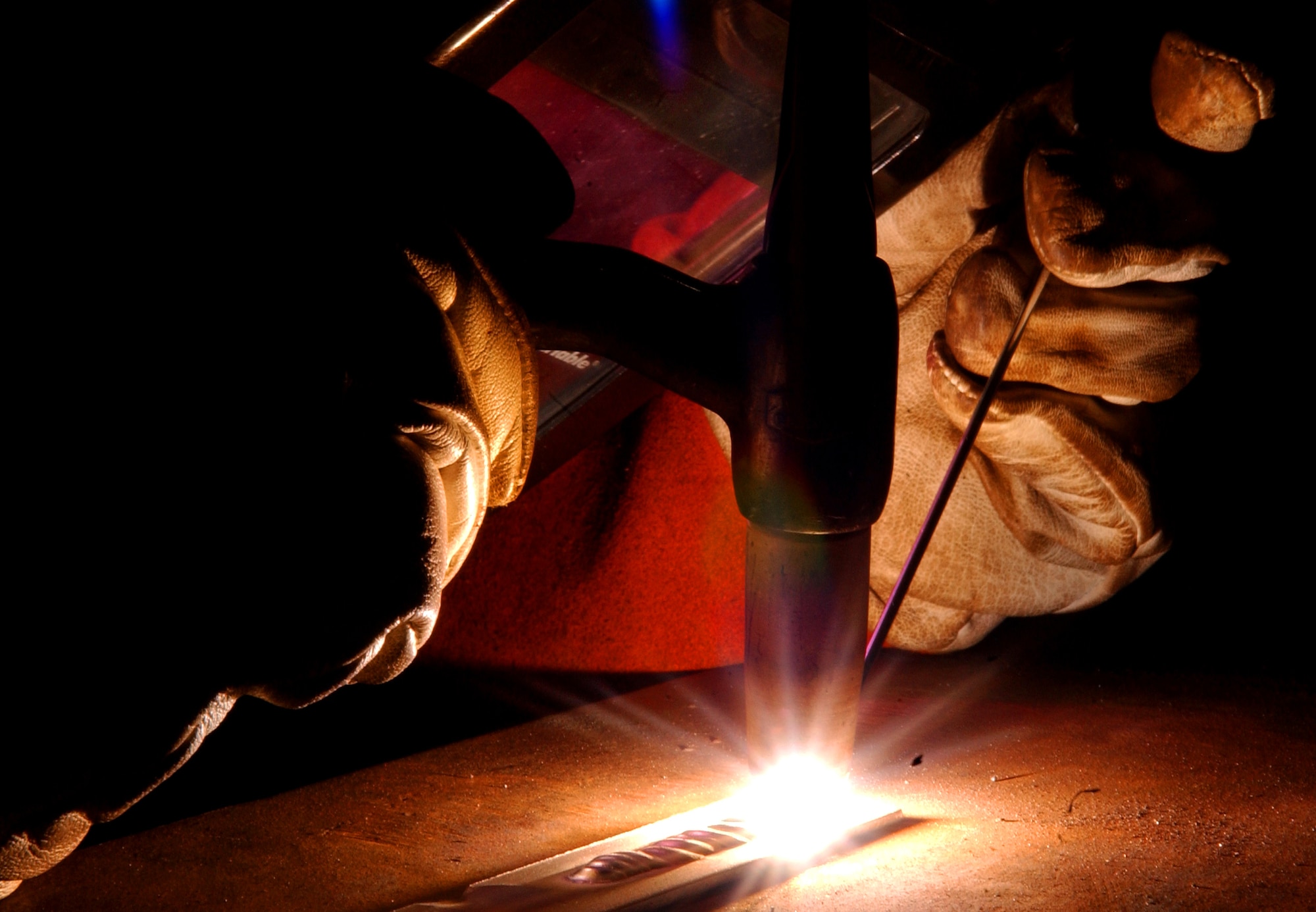 Airmen and local nationals practice oxyacetylene welding June 4 at Kadena Air Base, Japan. The process uses fuel gases and oxygen to cut and weld metals. Personnel from vehicle mechanics and body shop are completing a newly implemented welding course at the Pacific Air Forces Transportation Training Center.  (U.S. Air Force photo/Tech. Sgt. Rey Ramon)     