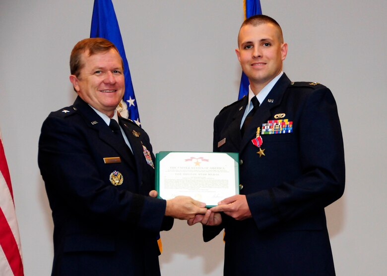 ANDERSEN AIR FORCE BASE, Guam - Capt. Raymond Kerr, 36th CES chief of construction management, receives a Bronze Star medal from Brig. Gen. Ruhlman during the May promotion ceremony here May 29. Captain Kerr and his joint-deployed team of more than 15 members took on the task of constructing the Afghan National Army’s and Afghan National Fleet’s facilities, including their bases and police stations. These facilities allowed the ability to bed down more than 700 Afghan forces. The Bronze Star Medal is awarded to members of all branches of military service and may be awarded either for combat heroism or for meritorious service. (U.S. Air Force photo by Airman 1st Class Courtney Witt)