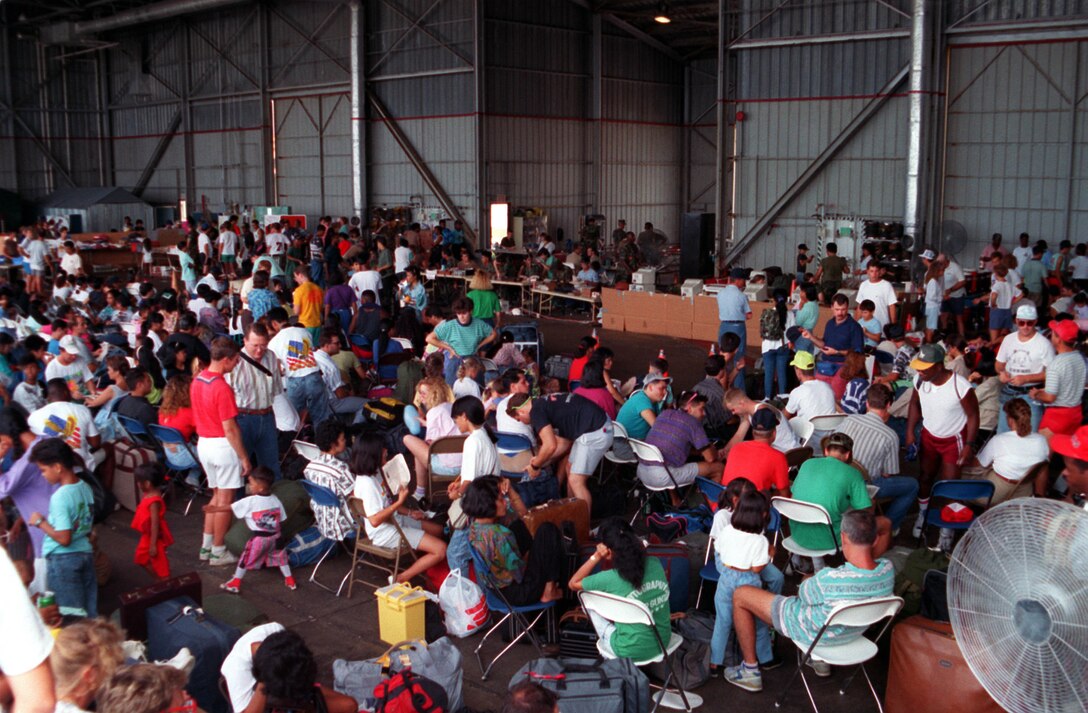 ANDERSEN AIR FORCE BASE, Guam - Refugees take shelter inside of one of Andersen's hangars after evacuating from Clark Air Base, Philippines, June 25, 1991.  American Airmen and their families fled Clark after Mt. Pinatubo volcano erupted.  (Courtesy photo). 
