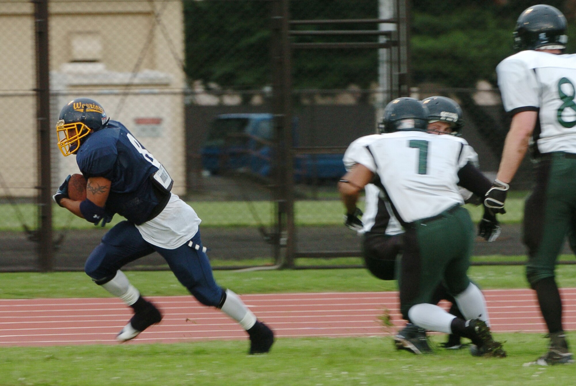 YOKOTA AIR BASE, Japan -- Yokota Warriors' receiver Michael Mathis jukes three Misawa Jets' defenders on his way to a 73-yard touchdown strike June 6 during the Warriors' 22-12 win over the Misawa Jets in U.S. Forces Japan-American Football League action. The win marked Yokota's first of the season, while Misawa dropped to 1-2. The Warriors' final home game at Bonk Field is set for 4 p.m. June 27 vs. Kadena. (U.S. Air Force photo/Master Sgt. Matt Summers)