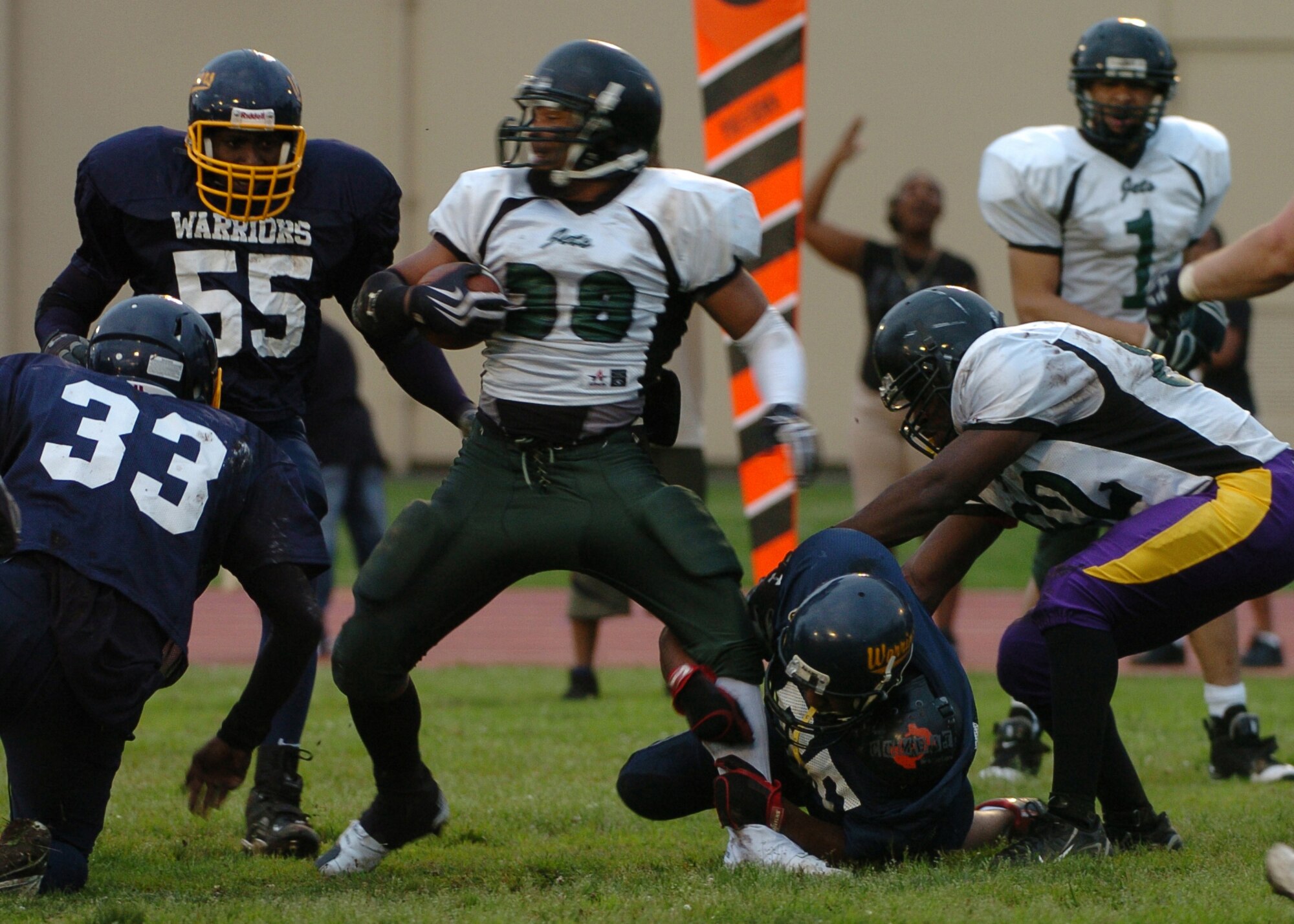 YOKOTA AIR BASE, Japan -- Yokota defensive lineman Quinn Floyd makes an ankle tackle on a Misawa Jets' running back June 6 in the Warriors' 22-12 win over the Jets. The win marked Yokota's first of the season, while Misawa dropped to 1-2. The Warriors' final home game at Bonk Field is set for 4 p.m. June 27 vs. Kadena. (U.S. Air Force photo/Master Sgt. Matt Summers)