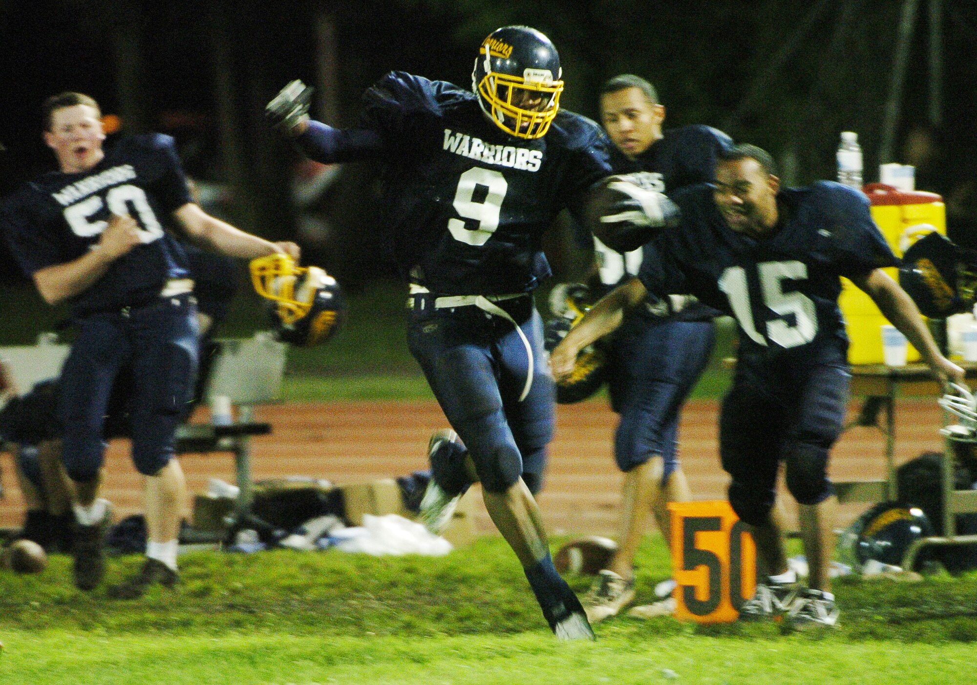 YOKOTA AIR BASE, Japan -- Yokota free safety Frederick Guild tight ropes down the sideline after setting a U.S. Forces Japan-American Football League-record with five interceptions June 6 in the Warriors' 22-12 win over the Misawa Jets. The win marked Yokota's first of the season, while Misawa dropped to 1-2. The Warriors' final home game at Bonk Field is set for 4 p.m. June 27 vs. Kadena. (U.S. Air Force photo/Master Sgt. Matt Summers)