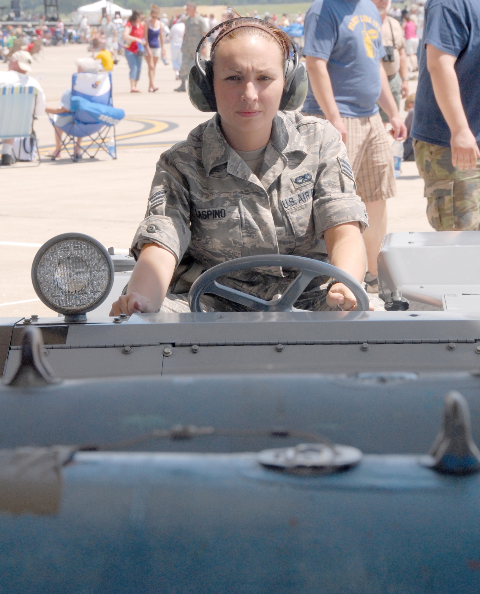Senior Airman Jennifer Laspino manuevers a jammer into position to pick up a 500-pound inert bomb from a trailer to load on an A-10 Thunderbolt II attack aircraft during the Wings Over Whiteman air show and open house June 6, 2009, at Whiteman Air Force Base, Mo.  Airman Laspino, Tech. Sgt. Ricky Schweim and Senior Airman Shane Dunn demonstrated their bomb-loading procedures to members of the public during the event.  All three are bomb loaders with the 442nd Aircraft Maintenance Squadron, part of the 442nd Fighter Wing, which is an Air Force Reserve unit based at Whiteman.  The wing, along with the 509th Bomb Wing, hosted Whiteman's first open house since 2006 and drew an estimated crowd of 30,000 people.  (U.S. Air Force photo/Maj. David Kurle)