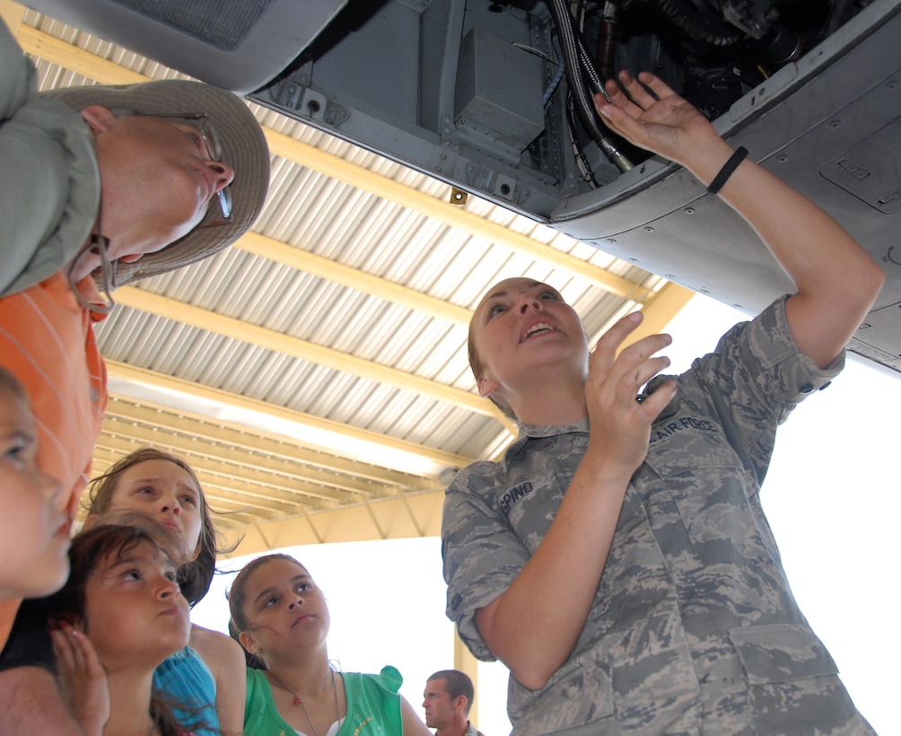 Senior Airman Jennifer Laspino answers questions about the A-10 Thunderbolt II attack aircraft during the Wings Over Whiteman air show and open house at Whiteman Air Force Base, Mo., June 6, 2009.  Airman Laspino is an Air Force reservist assigned to the 442nd Aircraft Maintenance Squadron as a bomb loader.  She and her teammates load bullets, bombs and other ordnance onto A-10s for the 442nd Fighter Wing.  The wing is an Air Force Reserve Command unit based at Whiteman and helped host the first open house at the base in three years, which drew an estimated 30,000 people.  (U.S. Air Force photo/Maj. David Kurle)