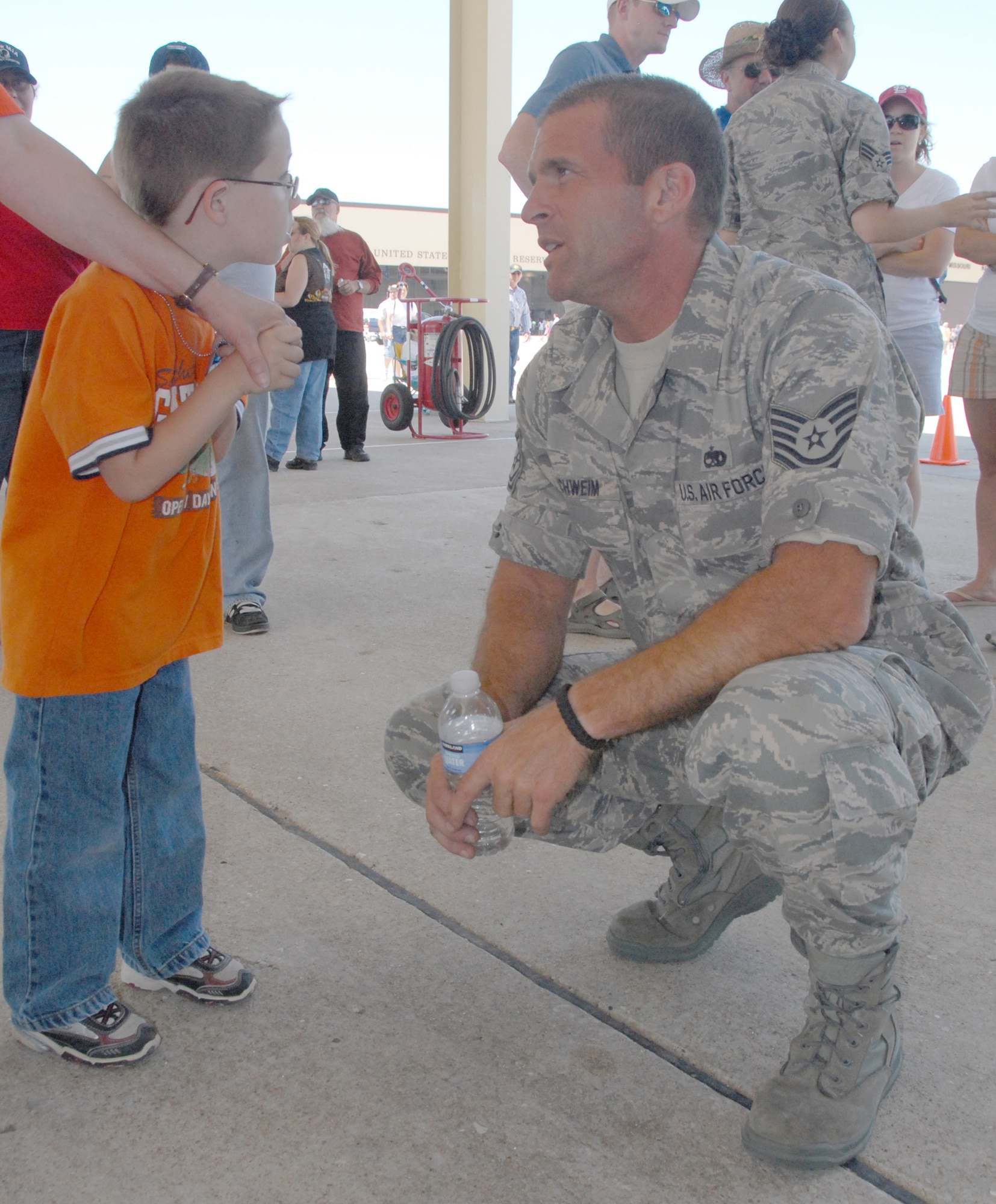 Tech. Sgt. Ricky Schweim answers 5-year-old Aiden Hopkins' questions about the the A-10 Thunderbolt II attack-aircraft during the Wings Over Whiteman air show June 6, 2009, at Whiteman Air Force Base, Mo.  Sergeant Schweim loads bombs, bullets and other ordnance on the A-10 and is an Air Force reservist in the 442nd Aircraft Maintenance Squadron, part of the 442nd Fighter Wing, based at Whiteman.  The wing helped host the air show along with the 509th Bomb Wing.  It was the first open house at Whiteman in three years and drew an estimated 30,000 people.  (U.S. Air Force photo/Maj. David Kurle)