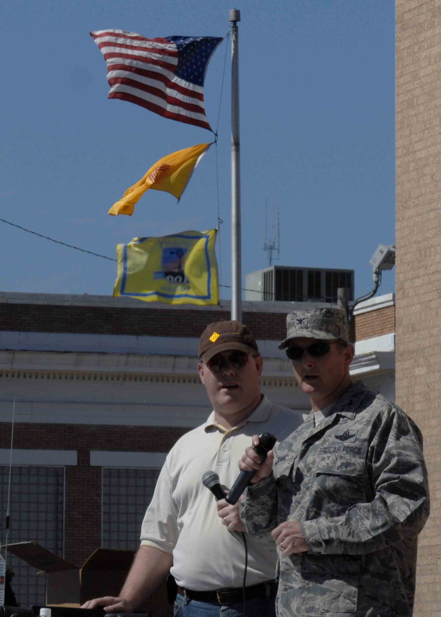 CANNON AIR FORCE BASE, N.M. -- Col. Stephen Clark, 27th Special Operations Wing commander alongside Steve Rooney, Mix 107.5 radio personality, speaks before the start of the 39th Annual Pioneer Parade in Clovis, N.M. June 6.  Col. Clark participated as one of the judges grading the parade entrants.  (U.S. Air Force photo/ Airman 1st Class James Bell)