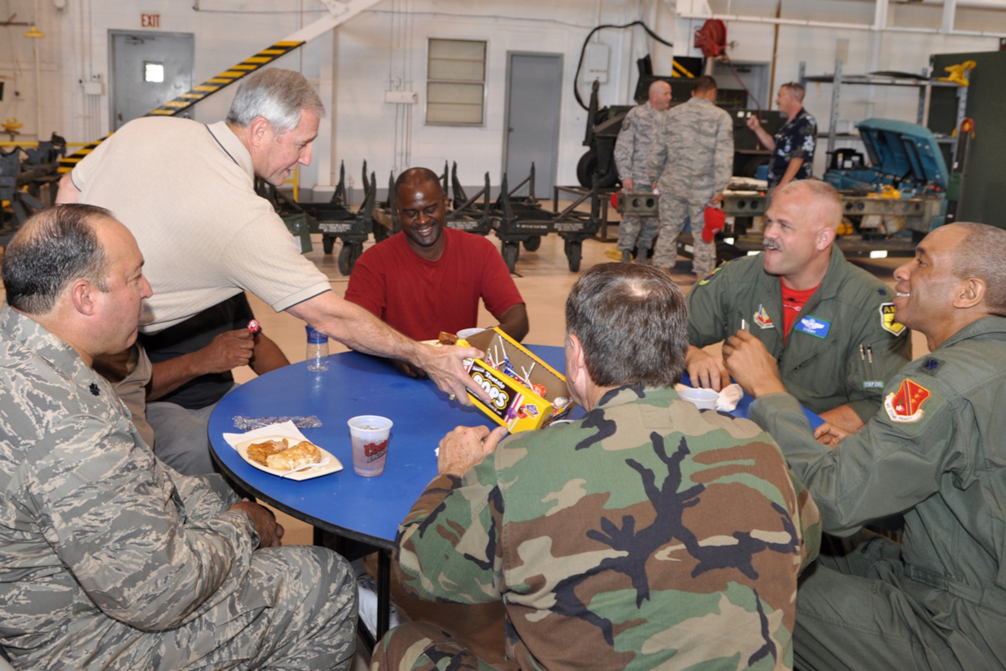 Chief Master Sgt. (Ret) Jack Skaggs, former 917th Wing, Command Chief Master Sgt., wanders through a crowd of Airmen passing out his signature candy bringing a smile to all who had a sweet tooth at the A-10 Hangar on Barksdale Air Force Base, La., June 5, 2009. Chief Skaggs helped serve lunch to 917th Airmen during a lunch provided by Raising Cane’s Chicken Finger restaurants in the Shreveport-Bossier area. (U.S. Air Force photo/Tech. Sgt. Jeff Walston) 