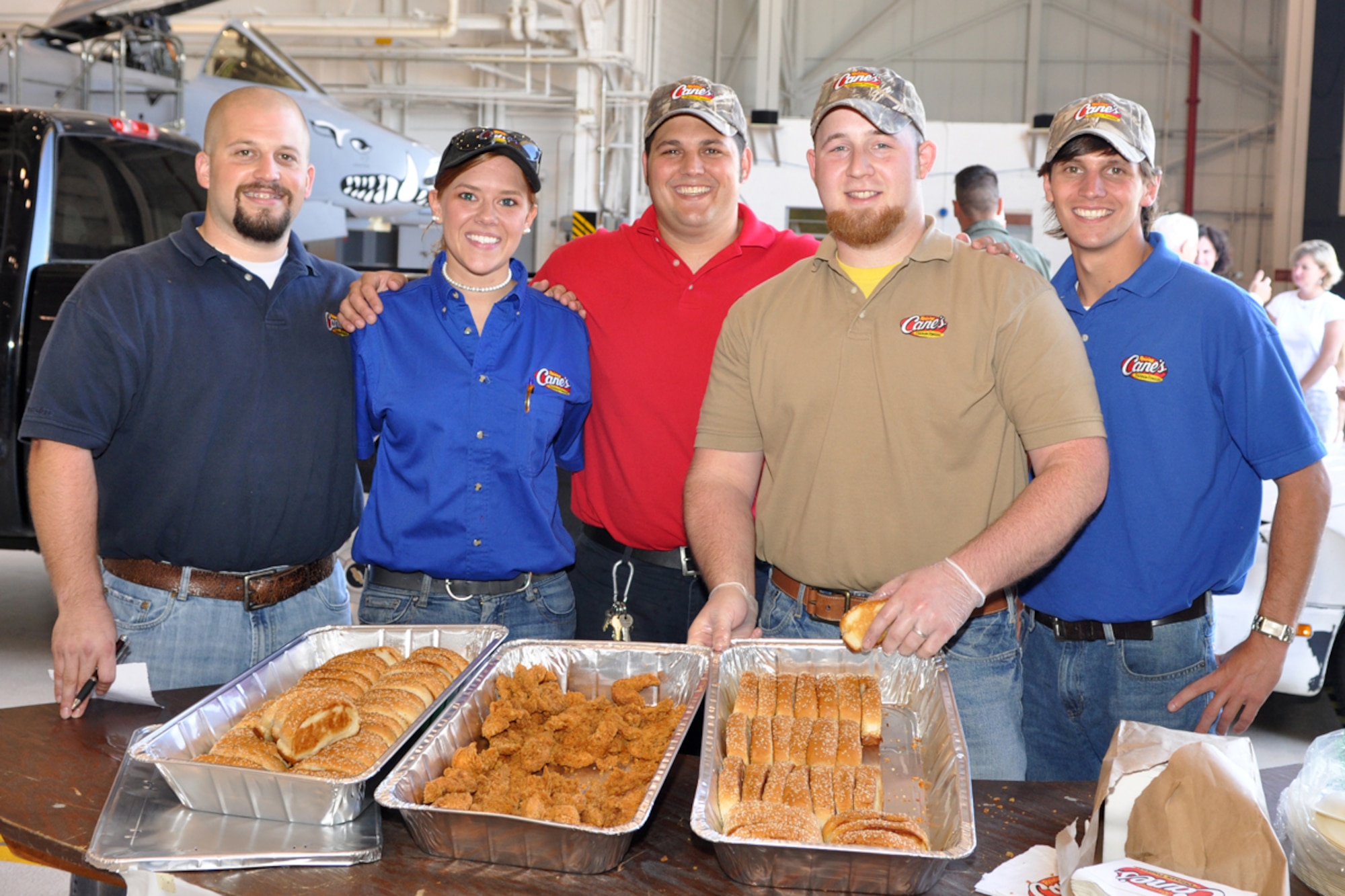 Pete John, Chelsy Sistrunk, Jack Skaggs, Alex Troegel and Mathew Snyder strike a pose in the A-10 Hangar at Barksdale Air Force Base, La., June 5, 2009. They are managers from several Shreveport-Bossier area Raising Cane’s Chicken Finger restaurants who pitched in to provide lunch for 917th Wing Airmen in an effort to “do their part in supporting local men and women who serve our country every day.” (U.S. Air Force photo/Tech. Sgt. Jeff Walston) 