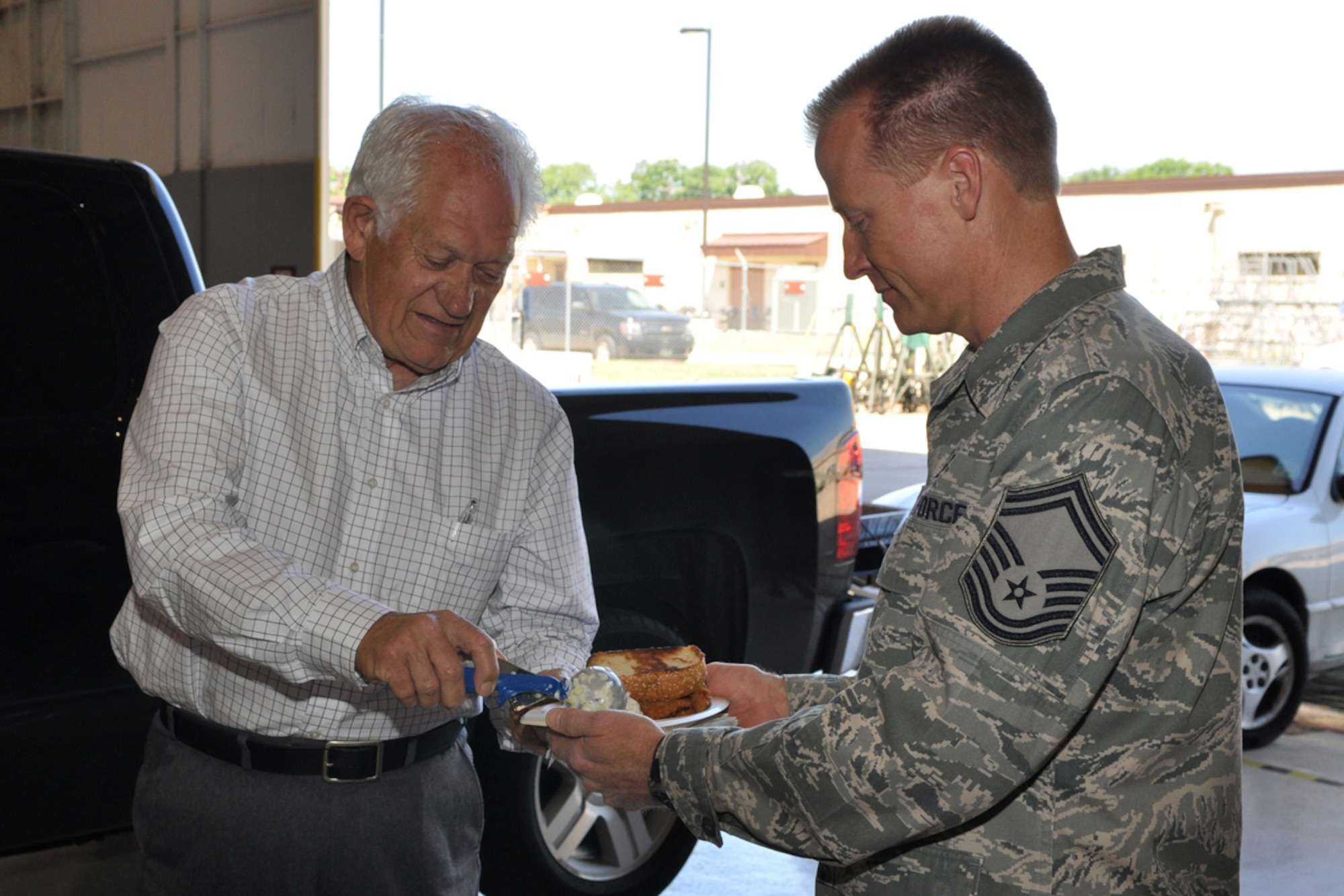Billy Wayne Montgomery, former representative to the Louisiana House of Representatives for District 9 (Bossier Parish) serves up coleslaw to Senior Master Sgt. Scott Moeller, 917th Maintenance Squadron, avionics flight chief, in the A-10 Hangar at Barksdale Air Force Base, La., June 5, 2009. Mr. Montgomery was one of many people who served lunch to the Airmen “in appreciation for what they do every day for the country.” (U.S. Air Force photo/Tech. Sgt. Jeff Walston)  