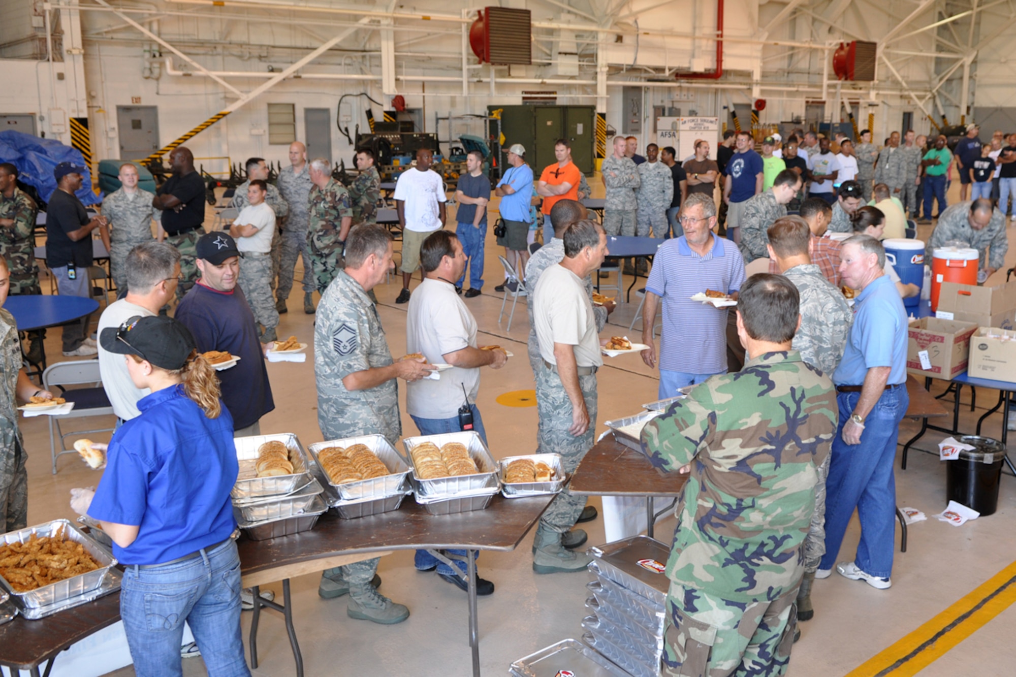 Airmen from the 917th Wing at Barksdale Air Force Base, La., form a line as managers from Raising Cane’s Chicken Fingers restaurants in the Shreveport-Bossier area serve up a chicken finger lunch for more than 400 wing personnel June 5, 2009, before the scheduled Unit Training Assembly weekend.  Managers from several of the restaurants pitched in to provide the lunch in an effort to “do their part in supporting local men and women who serve our country every day.” (U.S. Air Force photo/Tech. Sgt. Jeff Walston)