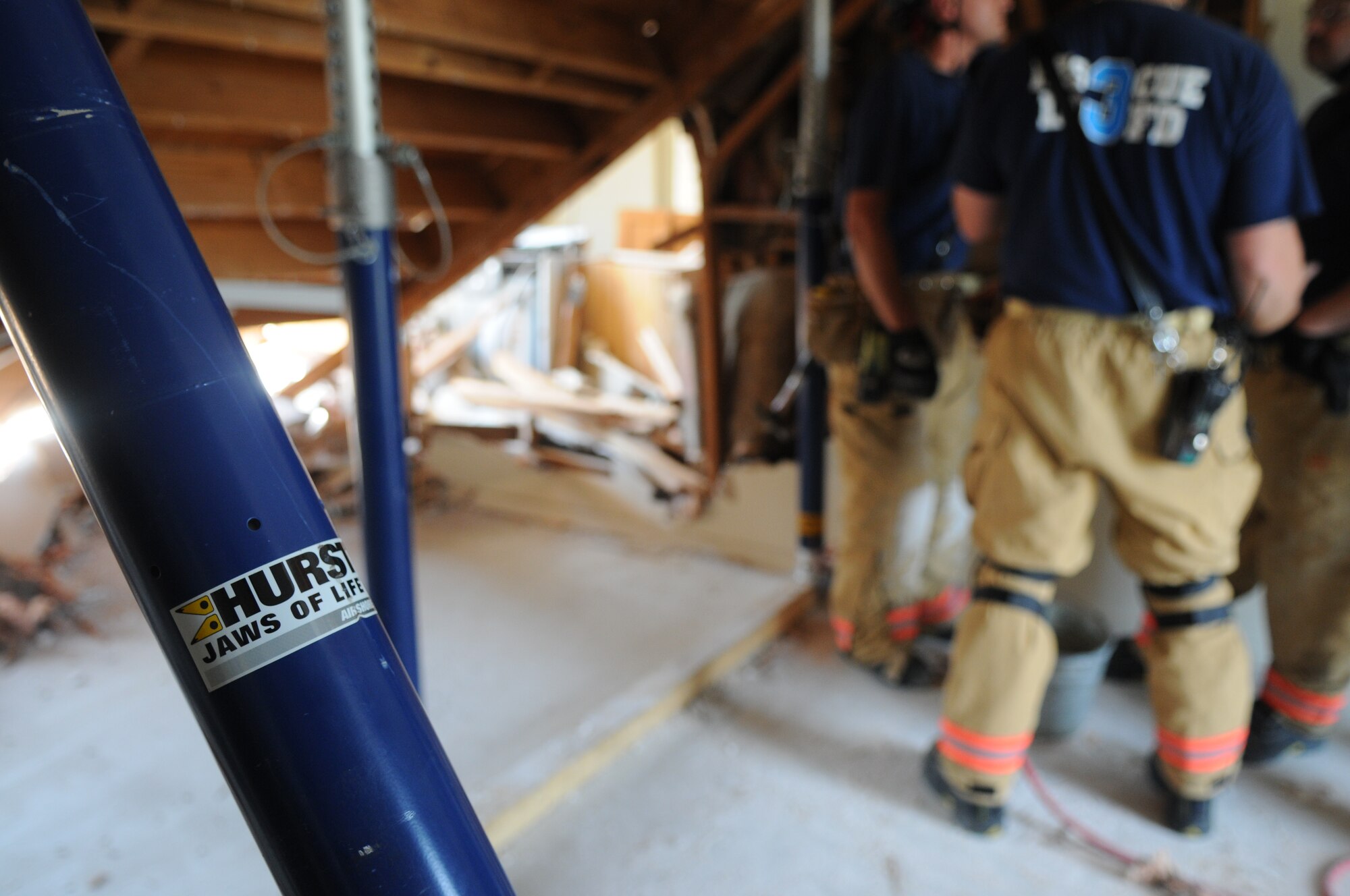The Naval District of Washington Fire Department and the District of Columbia Fire Department place stands to support a collapsed floor during a collapse-and-rescue exercise June 8 on Bolling Air Force Base. The coming demolition of Hickam Village housing created a prime location and opportunity June 1 - 12 for the joint training effort. (U.S. Air Force photo by Senior Airman Marleah Miller)