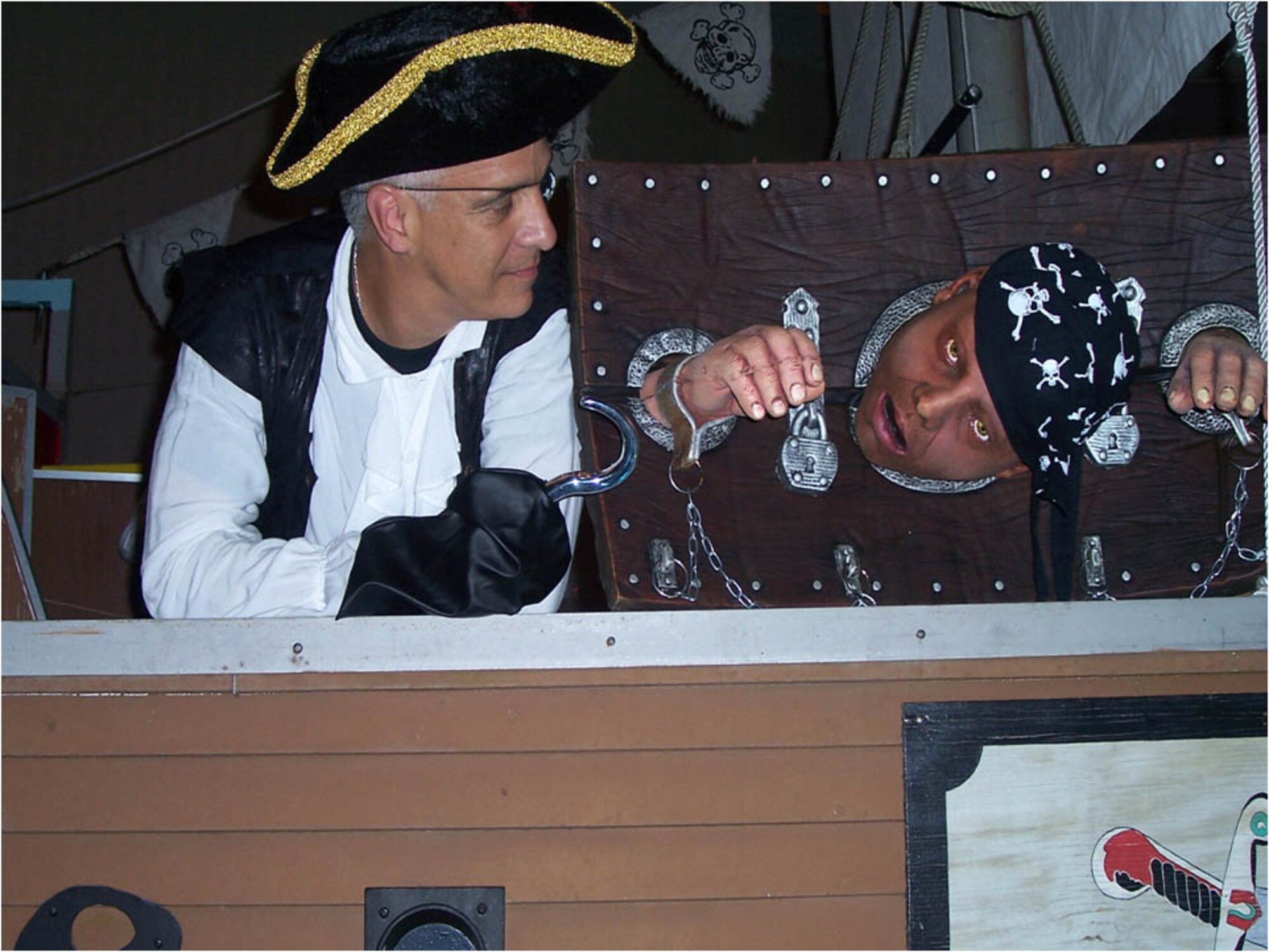 Col. Norbert Madera, left, smiles wryly at one of his
gruesome Halloween decorations.
