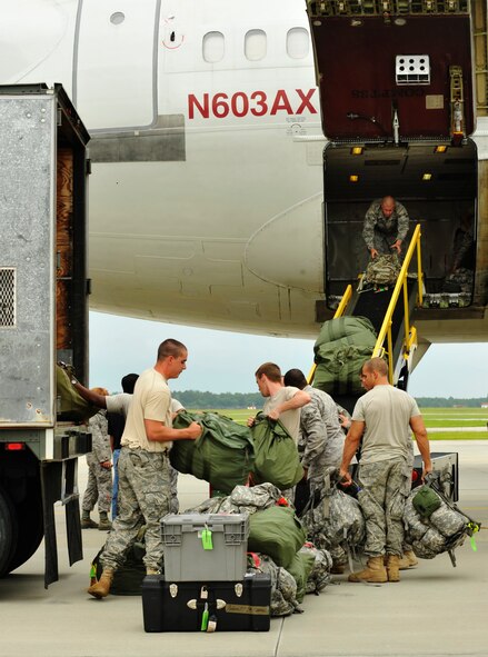 MOODY AIR FORCE BASE, Ga. -- Airmen from the 820th Security Forces Group load bags to an aircraft for members from the 822nd Security Forces Squadron who are leaving for a deployment here June 6. Members from the 822nd SFS are going to Camp Bucca, Iraq, where they will perform security operations and serve as convoy escorts. (U.S. Air Force photo by Senior Airman Schelli Jones)