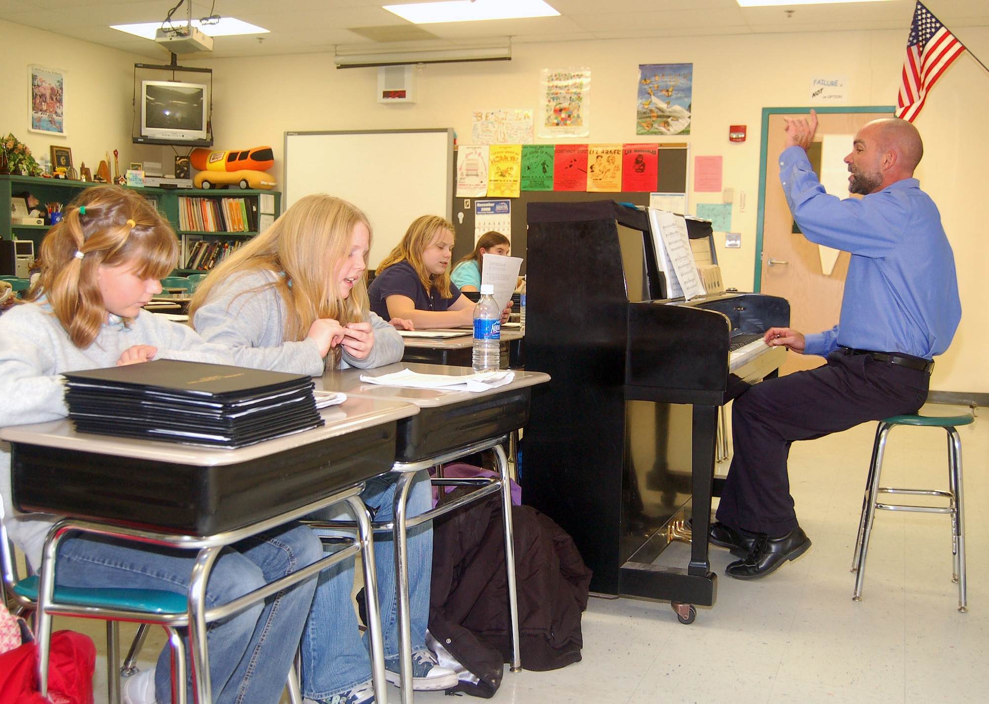 Mark Teesdale, a music and chorus teacher, instructs fourth and fifth grade students at Lake Forest Central Elementary School in Felton. The U.S. Air Force Thunderbirds aerial demonstration team selected Mr. Teesdale to fly with them June 19 as part of the Hometown Heroes program. The Thunderbirds are performing at the Dover Air Force Base Open House and Air Show June 20-21. (U.S. Air Force photo)
