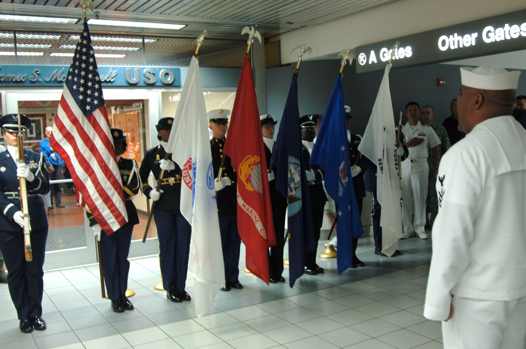The U.S. Transportation Command's Joint Service Color Guard presents the colors during the USO reopening at Lambert Airport in St. Louis June 3, 2009. It reopened after $300,000 worth of renovations gifted through the efforts of Dave Glover, 97.1 FM radio talk show host, and Marc Bulger, St. Louis Rams. Citing that "nothing is too good for our troops" the two gentlemen headed fundraising effort for the renovations that feature a child play/sleeping area, cyber cafe, gaming room, expanded media room, remodeled canteen and dining area, changing room and a larger luggae storage area. Representing the base was Col. Gary Goldstone, 375th Airlift Wing commander, who said the USO is a home to our troops wherever it may be and thanked them for their continued support of the nation's servicemembers. (Photo by Karen Petitt/375 AW/PA)