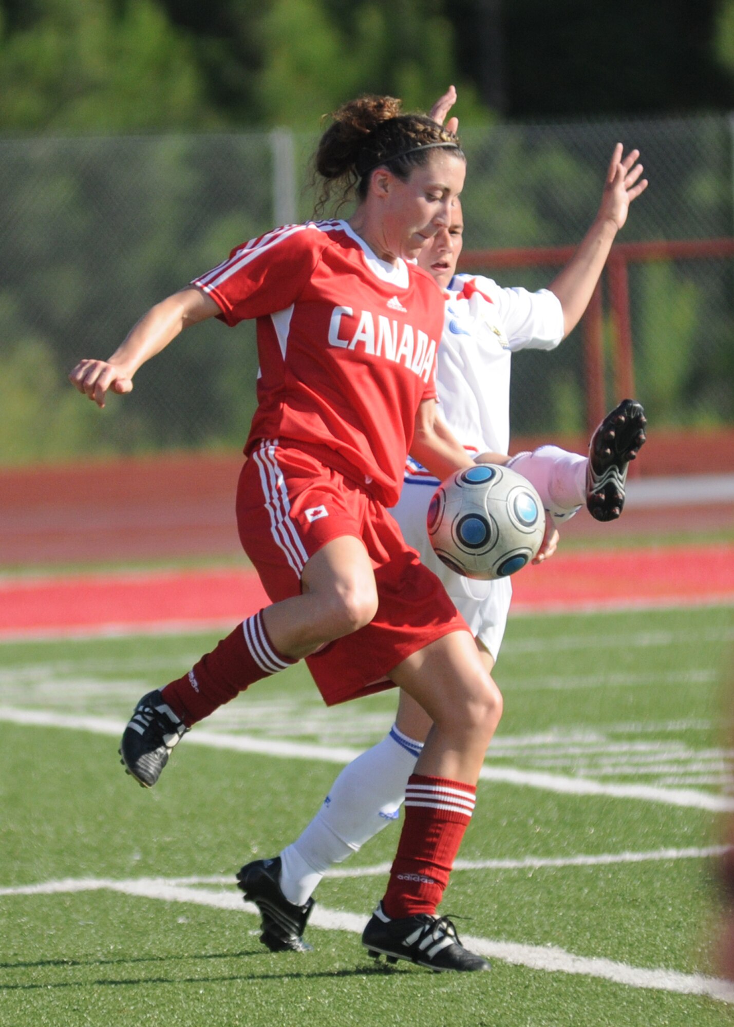 Canada and France compete during the 5th CISM Women’s Soccer Championship at Biloxi High School Stadium 7 June.  The CISM tournament, hosted by Keesler Air Force Base, includes teams from Brazil, Canada, France, Germany, The Netherlands, The Republic of South Korea and the United States.  Matches are being held June 6 to 13, with the Gold match June 13 at 2 p.m.  Organizers say the tournament gives teams and people who attend a chance to develop bonds and life-long friendships between the countries and a chance to learn about one another’s cultural similarities and differences.  (U.S. Air Force photo by Kemberly Groue)