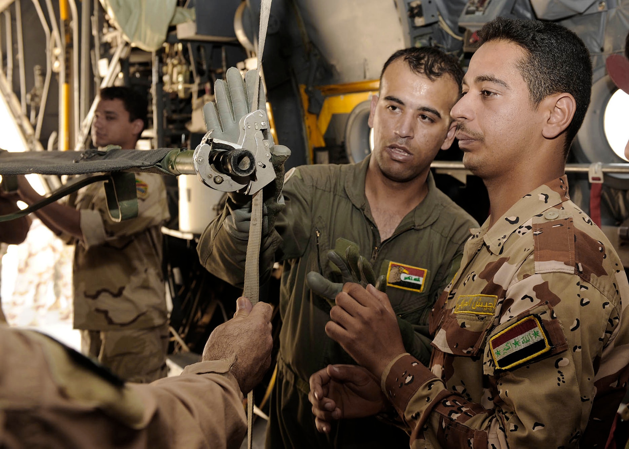 Iraqi air force Lt. Tahssen explains the procedures to reconfigure a C-130 for aeromedical evacuation transport to Iraqi flight medic students June 2 at New Al-Muthana Air Base, Iraq. The four-week course, once taught by U.S. instructors, is now instructed by Iraqis. Lieutenant Tahssen is a nurse and flight medic instructor. (U.S. Air Force photo/Senior Airman Jacqueline Romero) 
