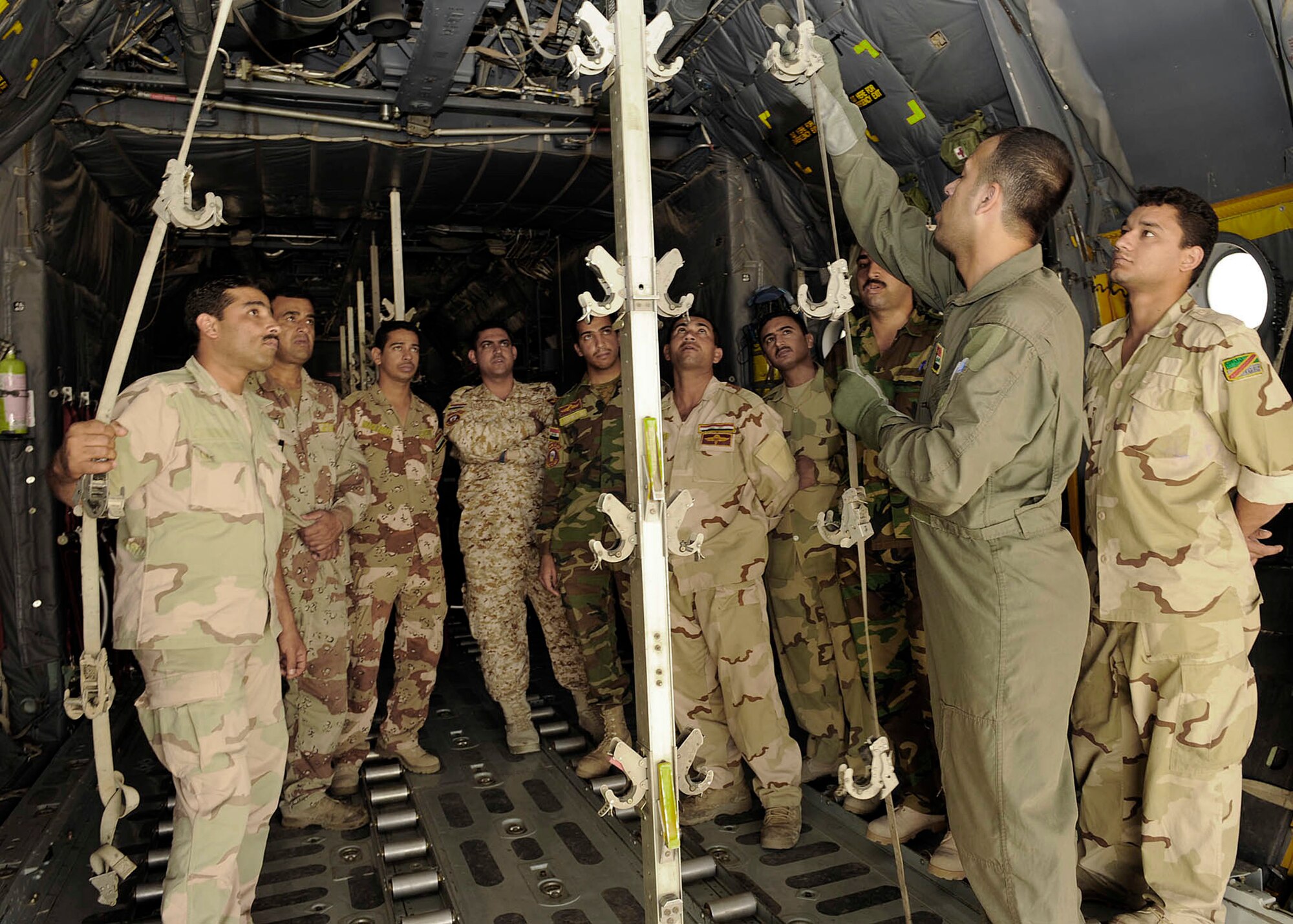 Iraqi air force Lt. Tahssen explains the procedures to reconfigure a C-130 for aeromedical evacuation transport to Iraqi flight medic students June 2 at New Al-Muthana Air Base, Iraq. The four-week course, once taught by U.S. instructors, is now instructed by Iraqis. Lieutenant Tahssen is a nurse and flight medic instructor. (U.S. Air Force photo/Senior Airman Jacqueline Romero) 

