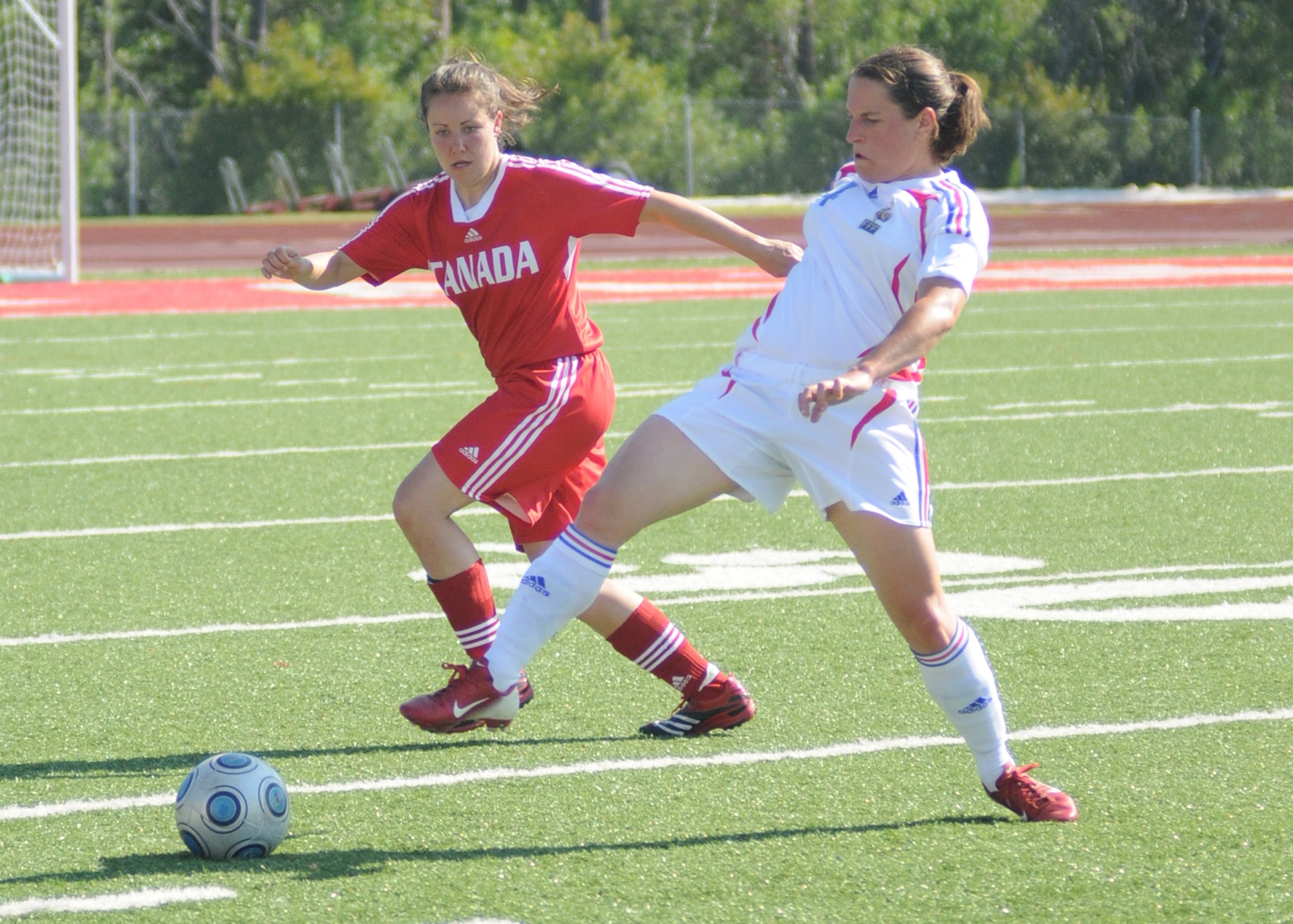Canada and France compete during the 5th CISM Women’s Soccer Championship at Biloxi High School Stadium 7 June.  The CISM tournament, hosted by Keesler Air Force Base, includes teams from Brazil, Canada, France, Germany, The Netherlands, The Republic of South Korea and the United States.  Matches are being held June 6 to 13, with the Gold match June 13 at 2 p.m.  Organizers say the tournament gives teams and people who attend a chance to develop bonds and life-long friendships between the countries and a chance to learn about one another’s cultural similarities and differences.  (U.S. Air Force photo by Kemberly Groue)