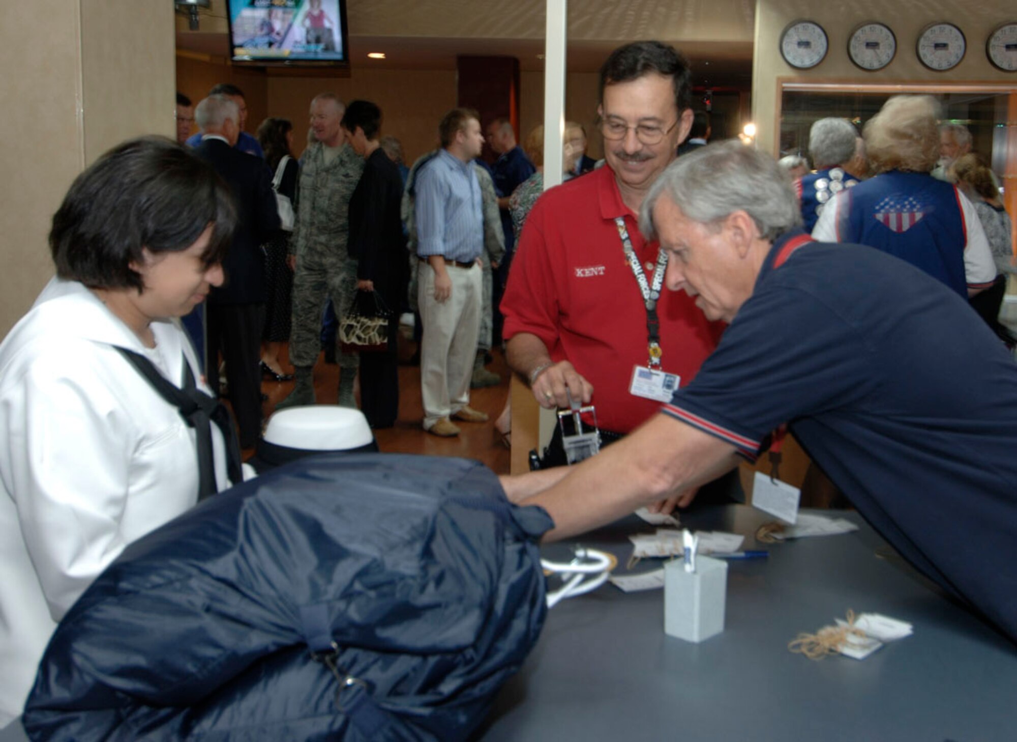USO volunteers Kent Ernst  and Will Bowers help servicmembers keep track of their luggage as they relax in the newly renovated USO at Lambert Airport in St. Louis, which re-opened June 3, 2009, after $300k worth of improvements gifted through the efforts of Dave Glover, 97.1 FM radio talk show host, and Marc Bulger, St. Louis Rams. Citing that "nothing is too good for our troops" the two gentlemen headed fundraising effort for the renovations that feature a child play/sleeping area, cyber cafe, gaming room, expanded media room, remodeled canteen and dining area, changing room and a larger luggae storage area. Representing the base was Col. Gary Goldstone, 375th Airlift Wing commander, who said the USO is a home to our troops wherever it may be and thanked them for their continued support of the nation's servicemembers. (Photo by Karen Petitt/375 AW/PA)