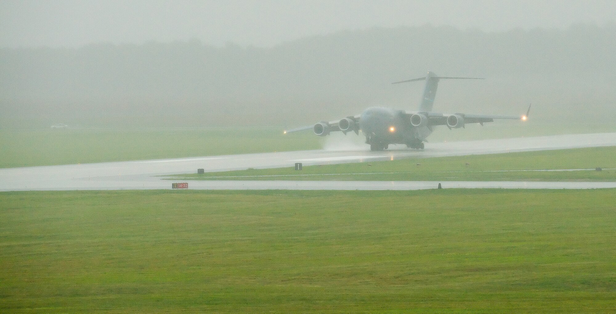 A C-17 Globemaster III, piloted by Col. Manson Morris, 436th Airlift Wing commander, lands on runway 14/32 at Dover Air Force Base, Del., June 5. Colonel Morris piloted the inaugural flight to utilize the newly reconstructed runway, which was turned over from the contractor to base officials June 5. (U.S. Air Force photo/Jason Minto) 