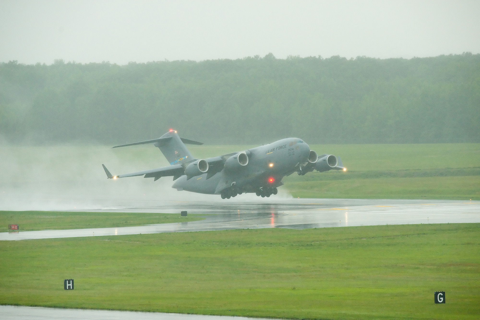 A C-17 Globemaster III, piloted by Col. Manson Morris, 436th Airlift Wing commander, takes off from runway 14/32 at Dover Air Force Base, Del., June 5. Colonel Morris flew the first aircraft to utilize the newly reconstructed runway, a 17-month project. (U.S. Air Force photo/Jason Minto)