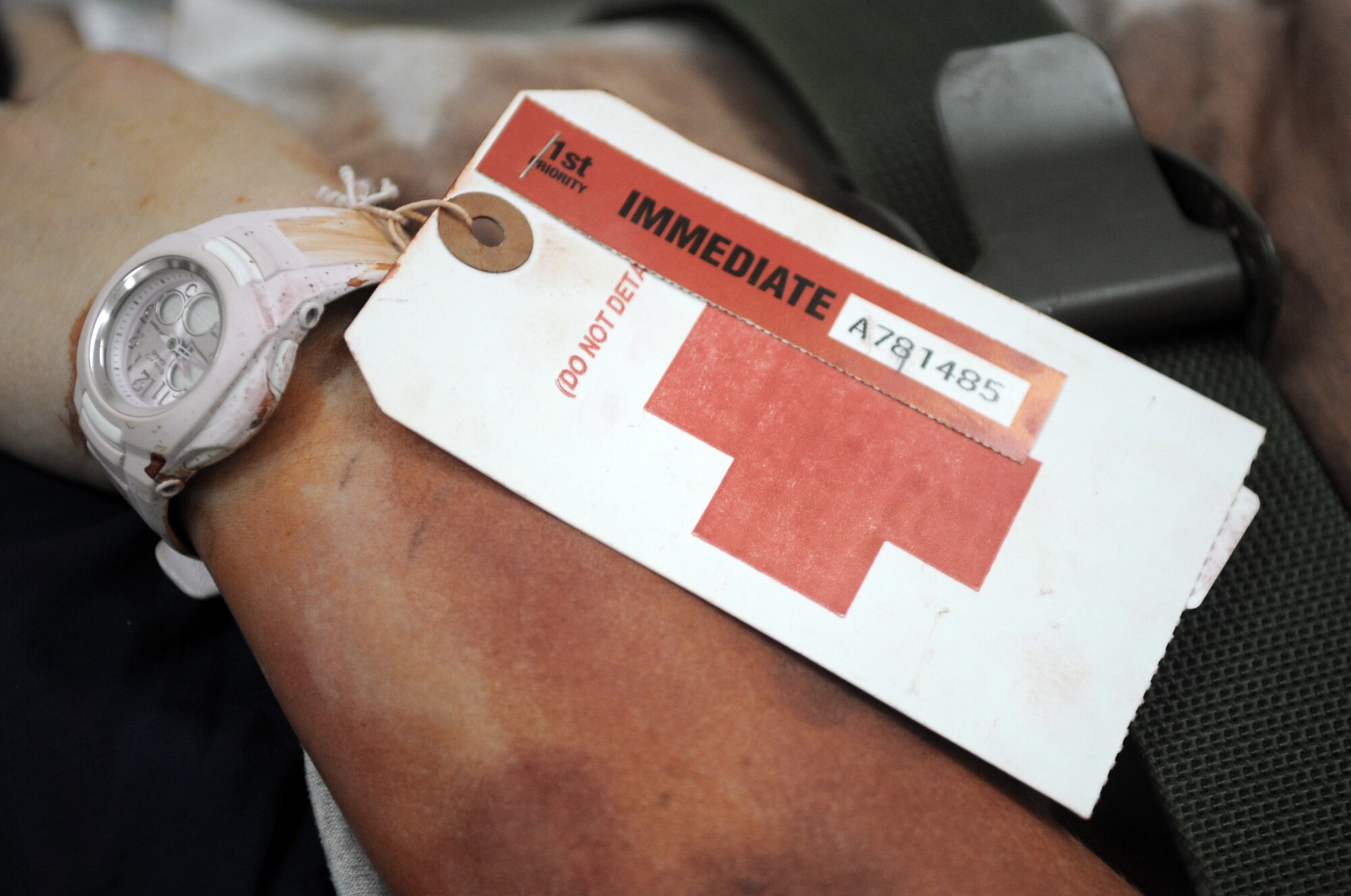 A patient is transported to the Air Force Theater Hospital with a tag that describes her medical condition during a major accident response exercise June 5 at Joint Base Balad, Iraq. The purpose of a MARE is to test the responsive actions of emergency response and medical personnel. (U.S. Air Force photo/Senior Airman Elizabeth Rissmiller) 
