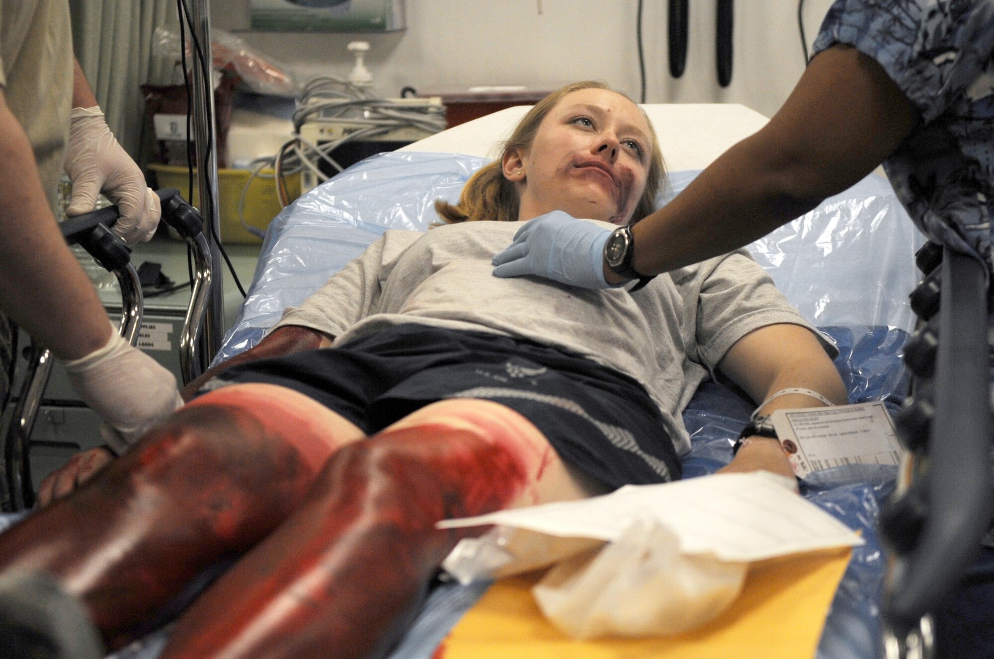 Senior Airman Kara Grizzle receives simulated medical attention at the Air Force Theater Hospital during a major accident response exercise June 5 at Joint Base Balad, Iraq. The scenario was a downed aircraft in which she sustained burns on 30 percent of her body. Airman Grizzle is a 332nd Expeditionary Civil Engineer Squadron logistics journeyman. (U.S. Air Force photo/Senior Airman Elizabeth Rissmiller) 
